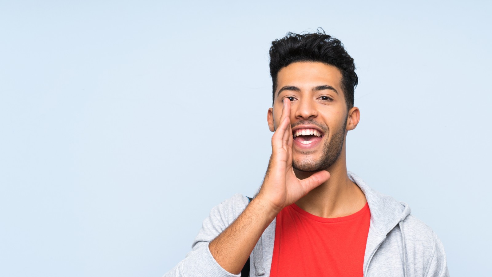 Man in fitness attire shouting/talking whilst cupping mouth