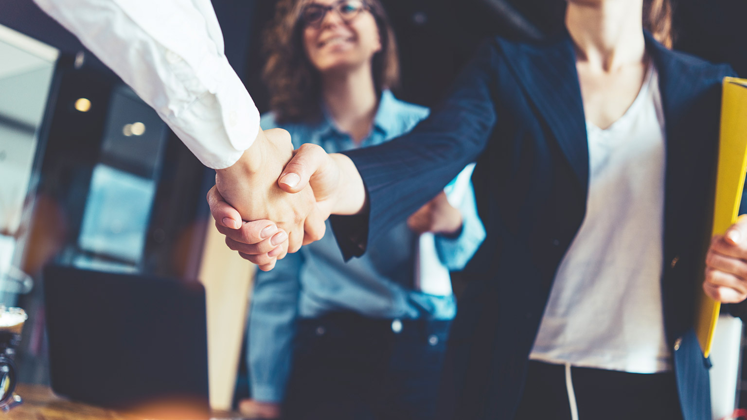 Business people shaking hands after completing a deal