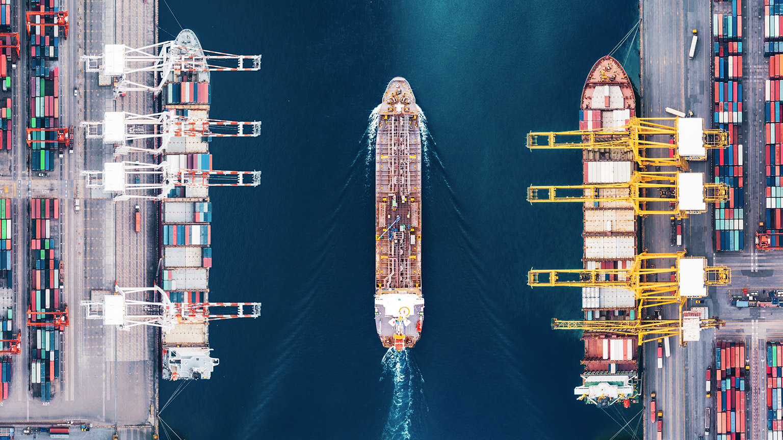 Top down view of container ship being loaded in port