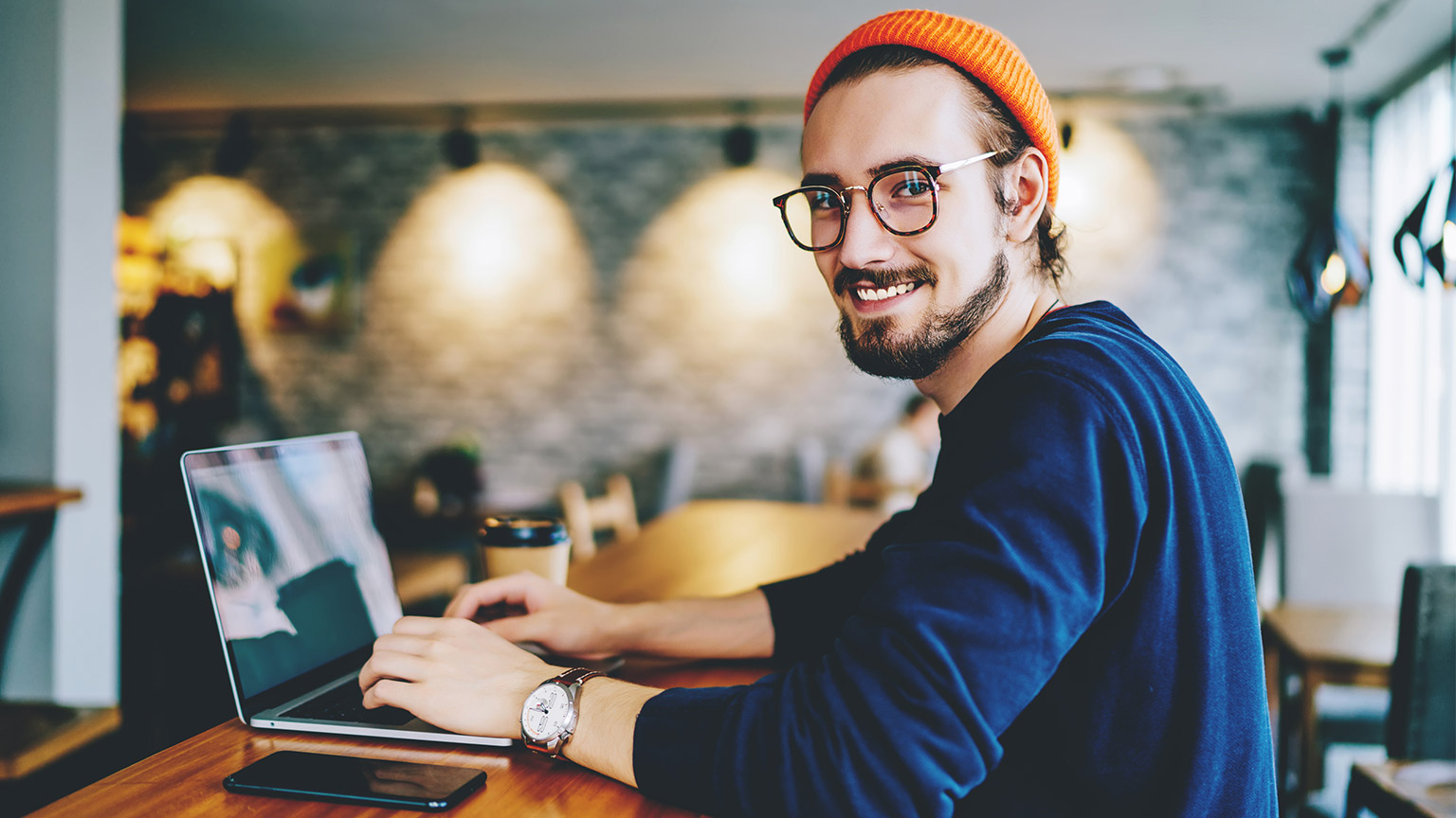 Hipster designer smiling at camera