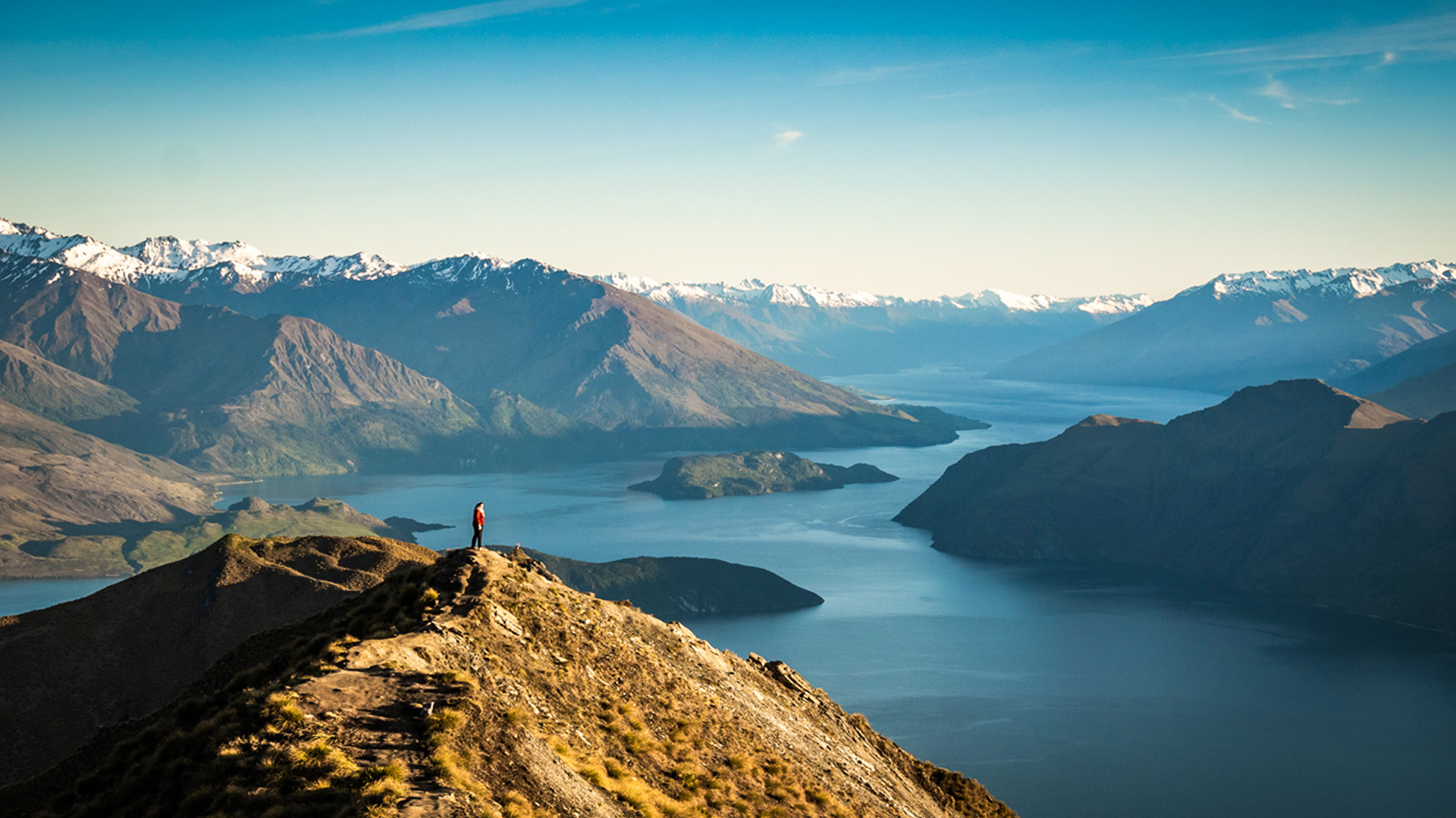 Woman standing on Roys Peak summit, New Zealand