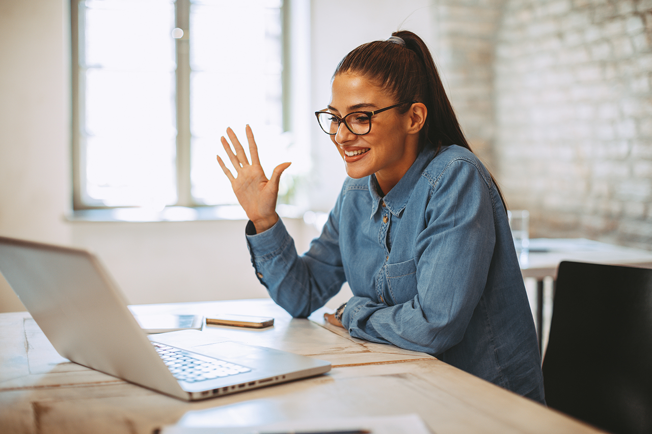 Young woman on video call conference in home office