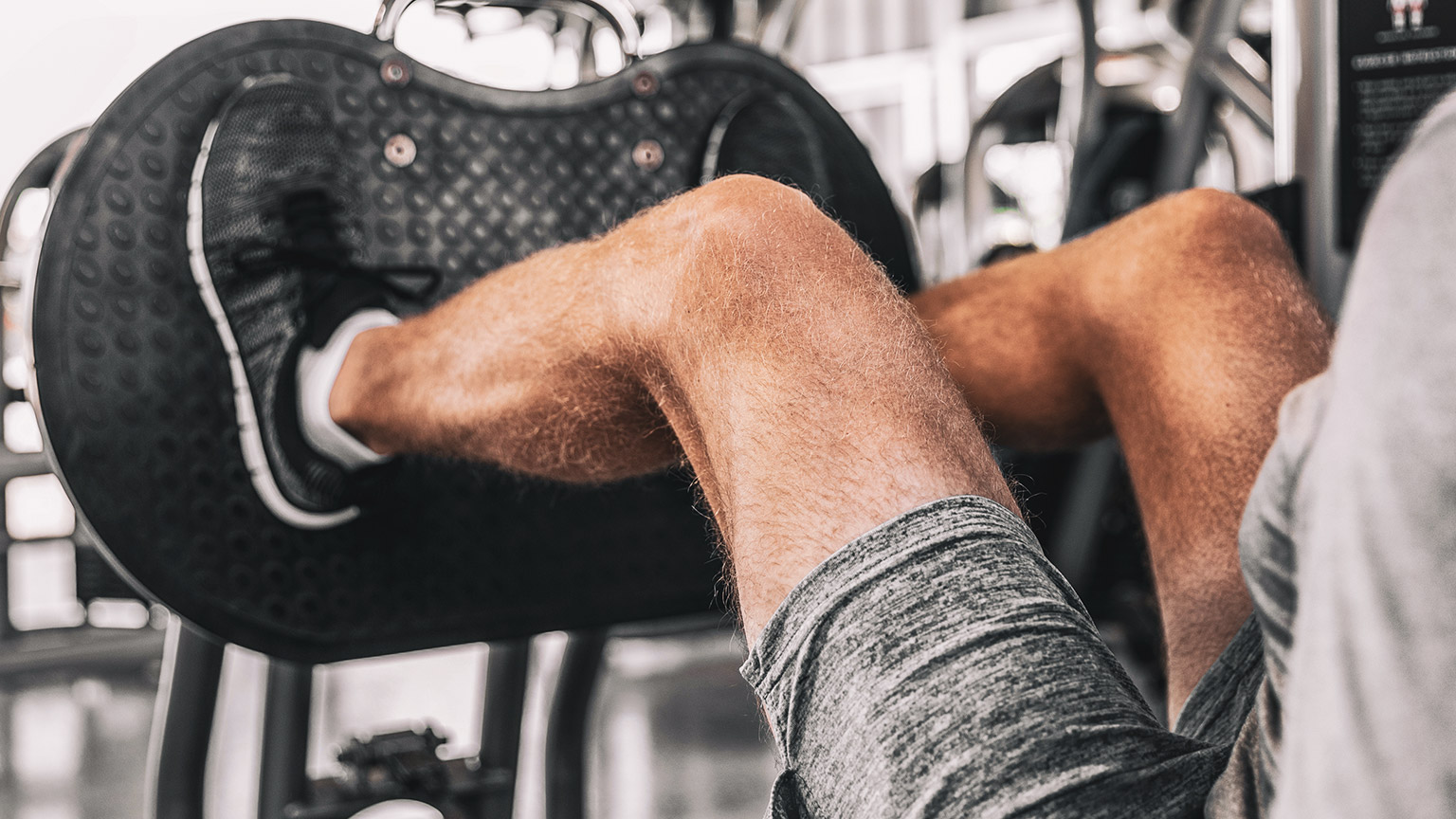 Man using leg press with focus on the knee joint