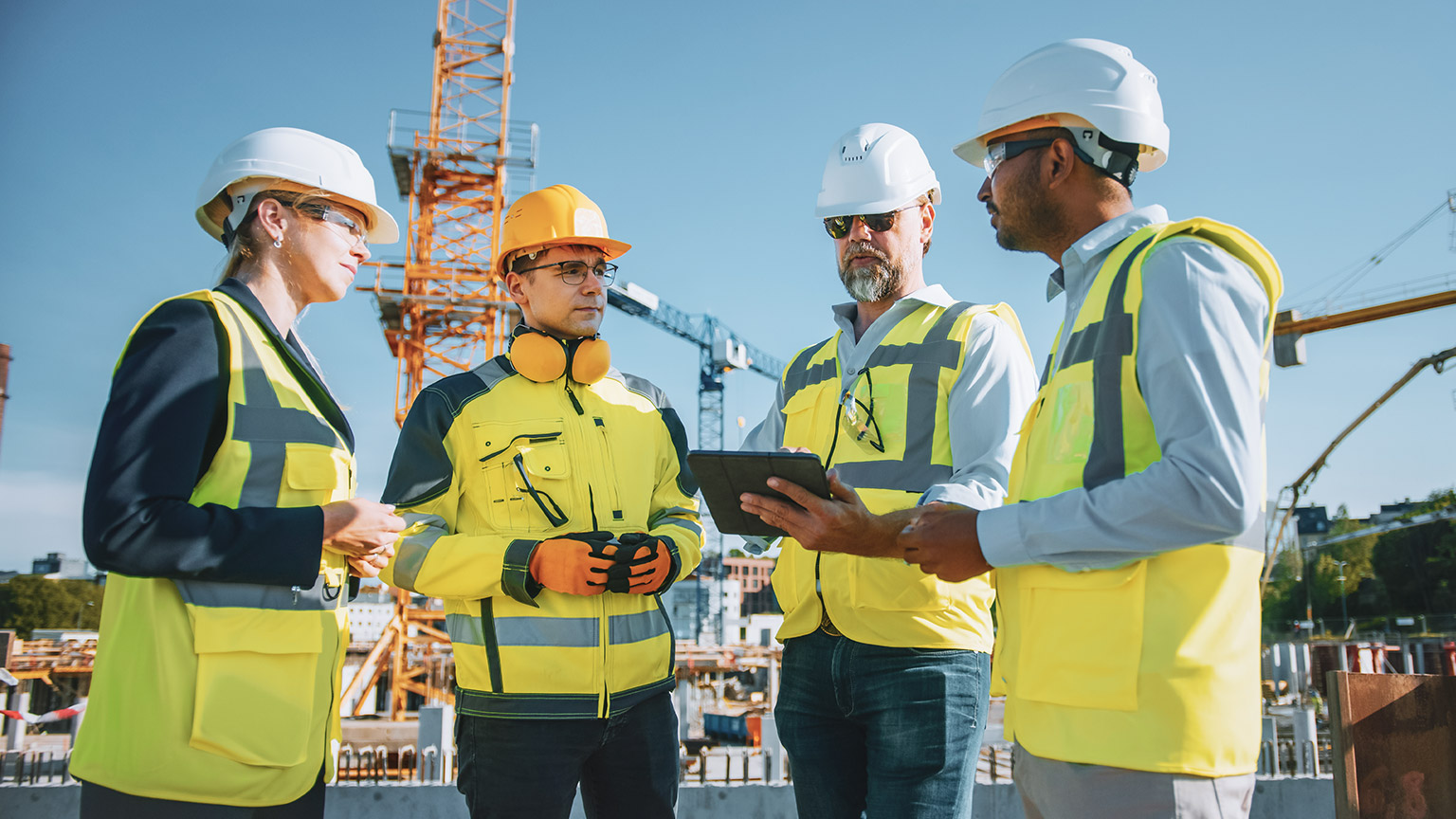 Group of work supervisors on building site discussing project