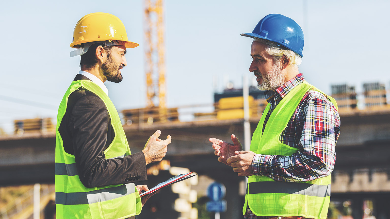 A foreman and worker resolving an issue on a job site