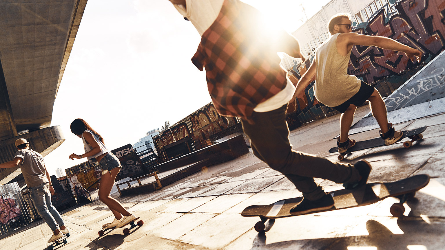 A group of people skateboarding in an urban area