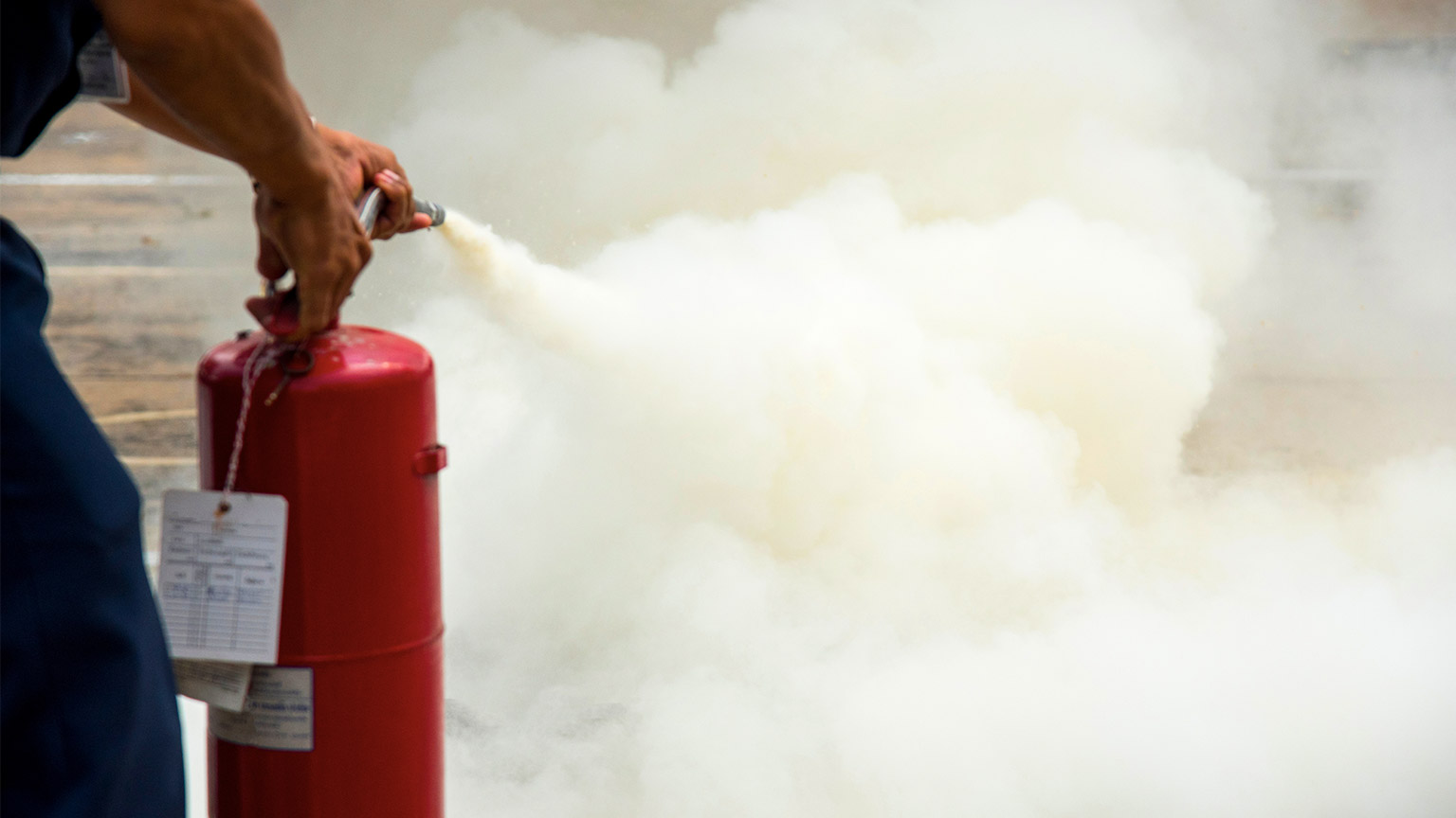 A person extinguishing a fire in the workplace