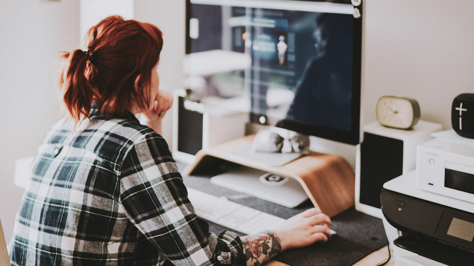 A professional in an office, collating online resources relating to their work