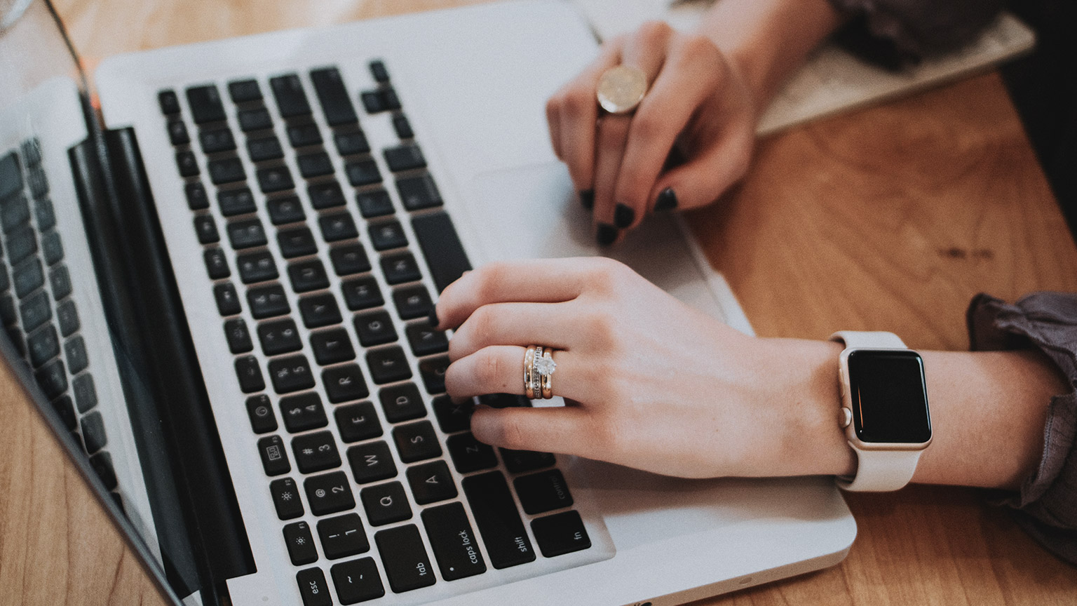 A close view of a business professional using a laptop to search for WHS-related information