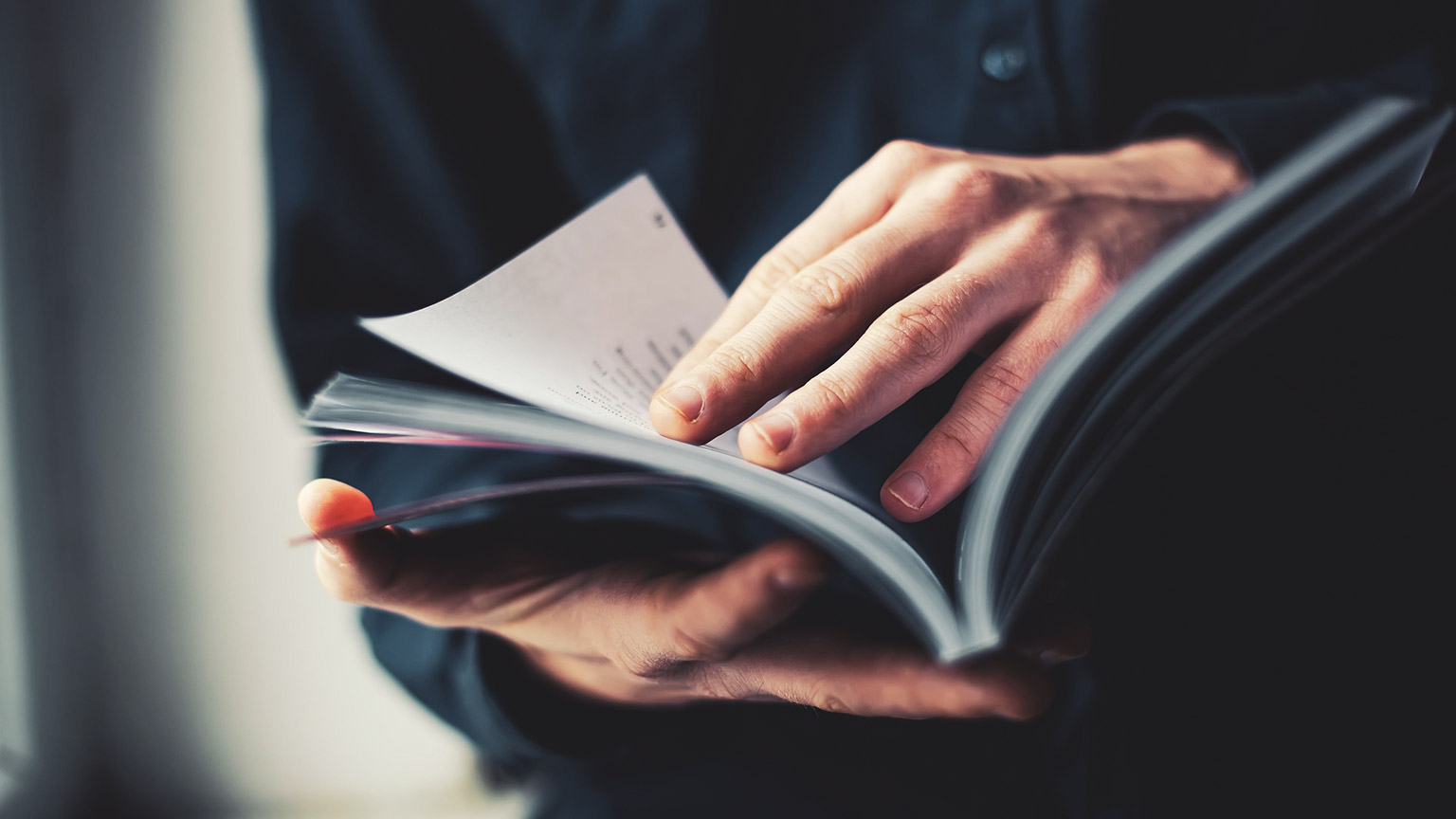 A close view of a person reading a construction industry publication