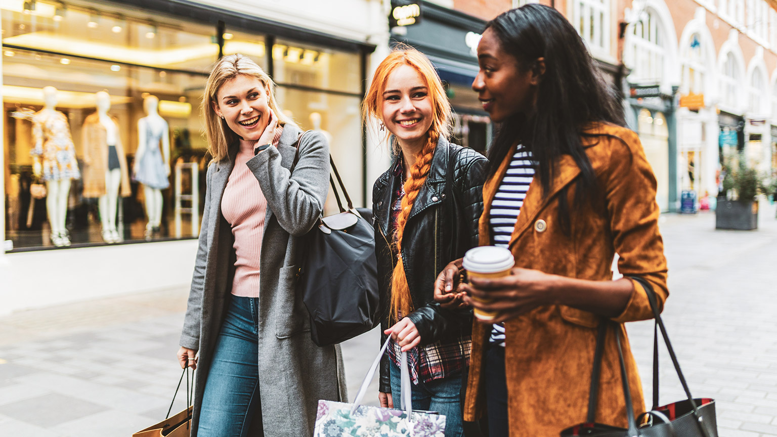 Three young women enjoying a spot of shopping in the city