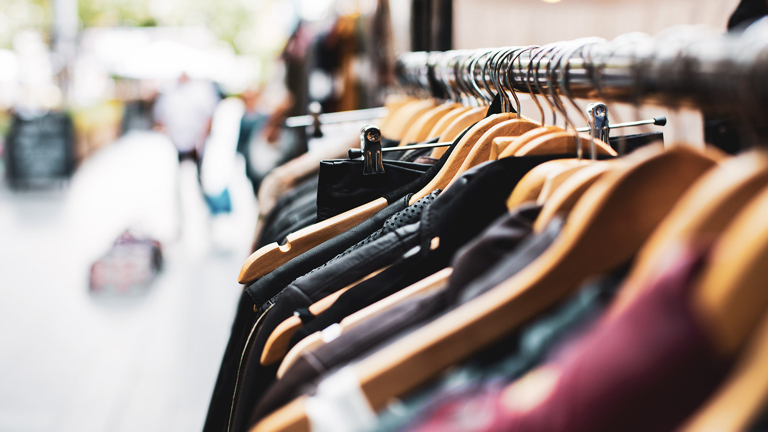 A close view of a rack of clothes in a shop