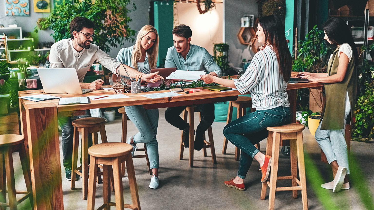 A group of colleagues working on a group project in a casual office environment