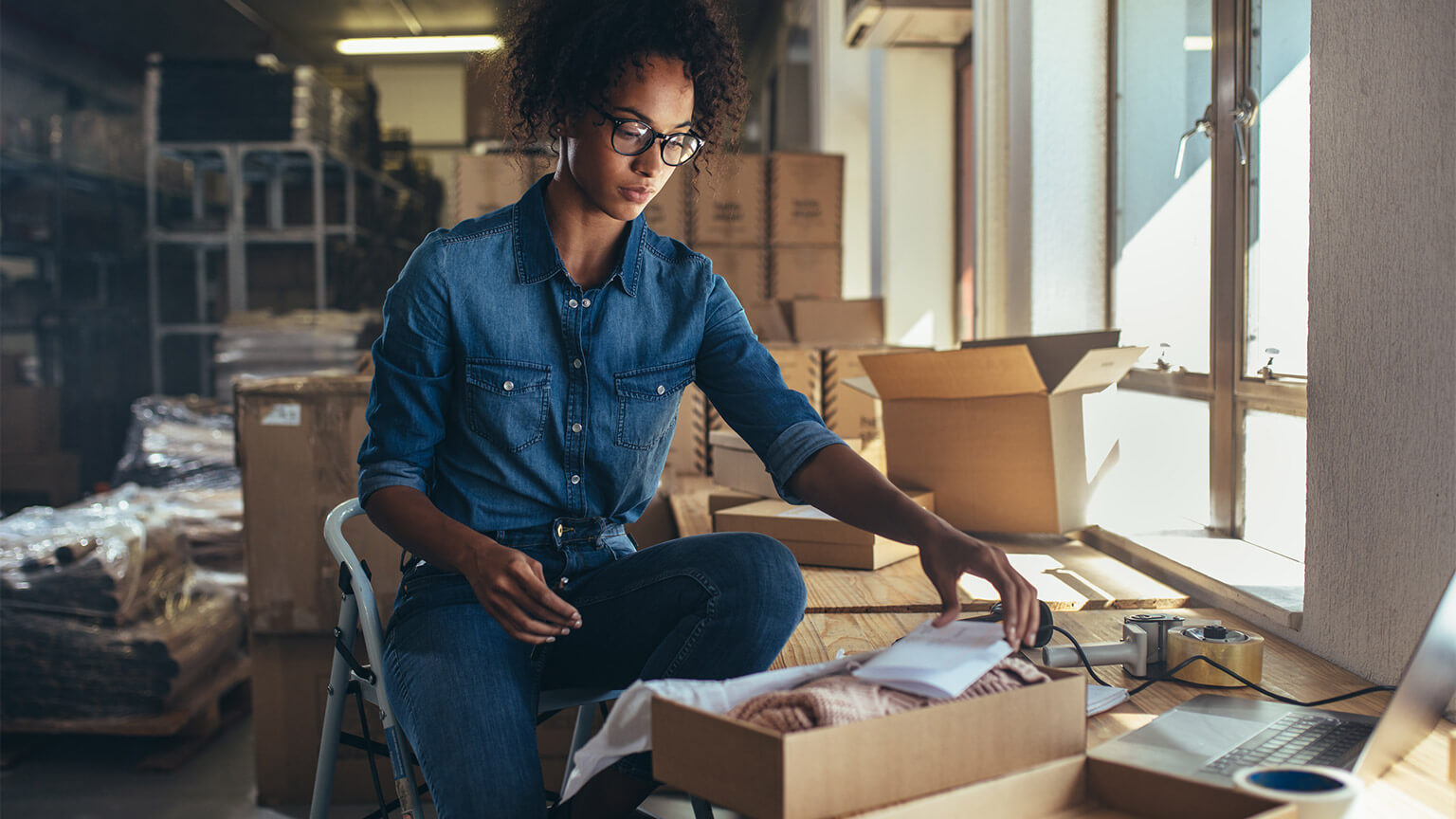 A small business owner packaging and online order for delivery