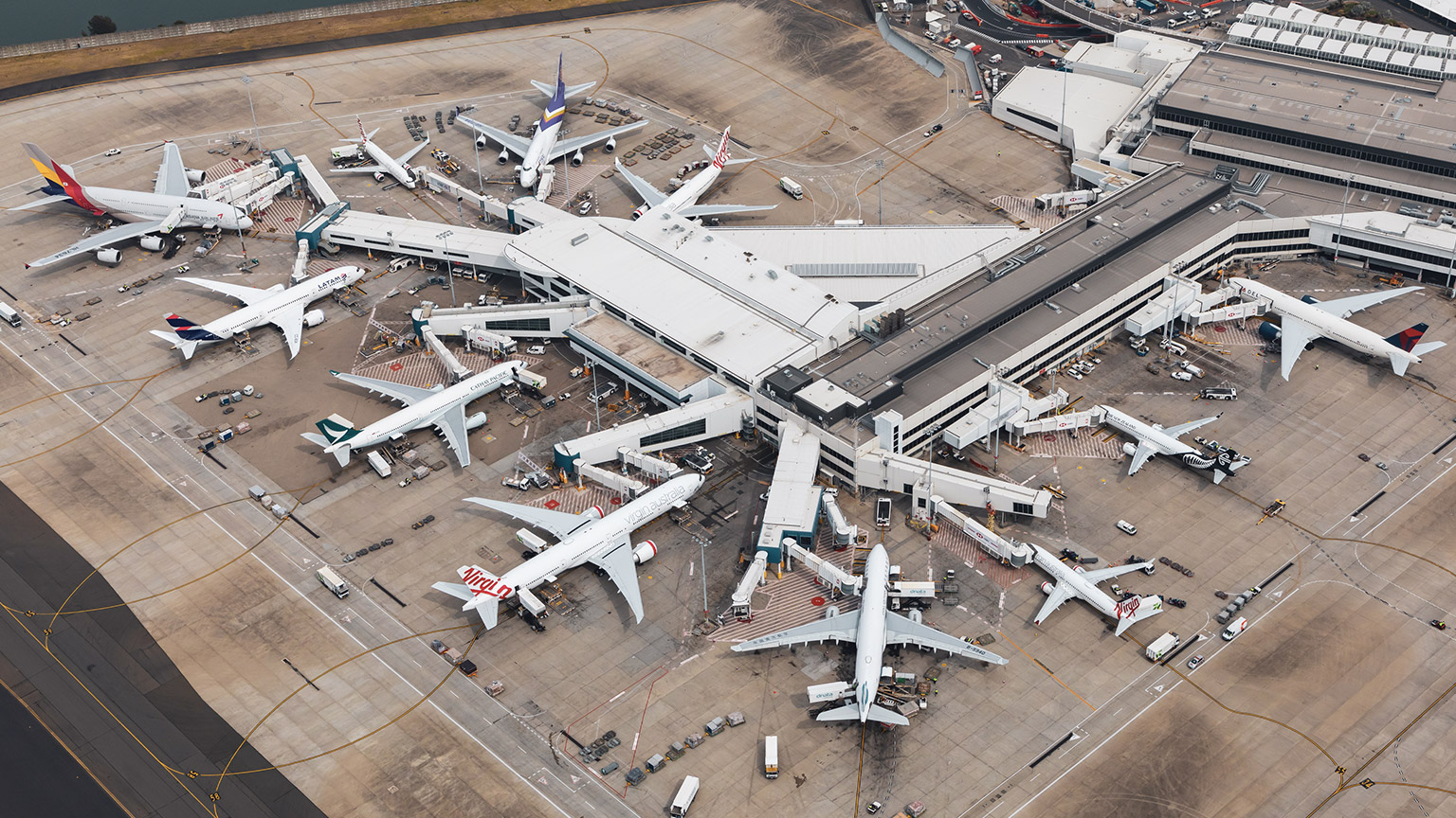 An overview of an airport with many longhaul aircraft from different countries