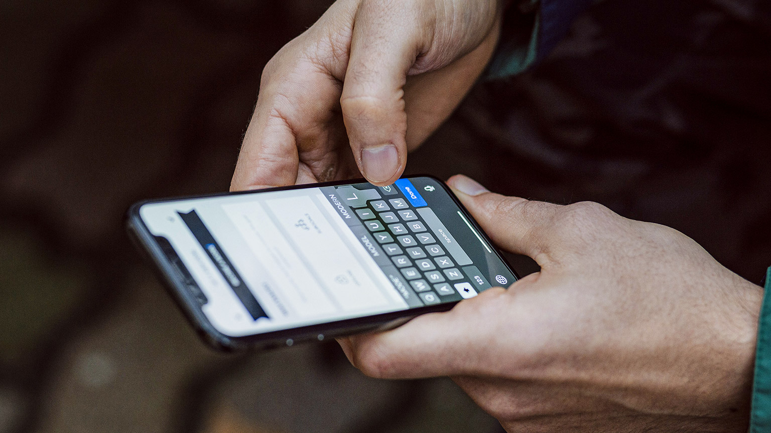 A close up of a person filling out a form on their smart phone