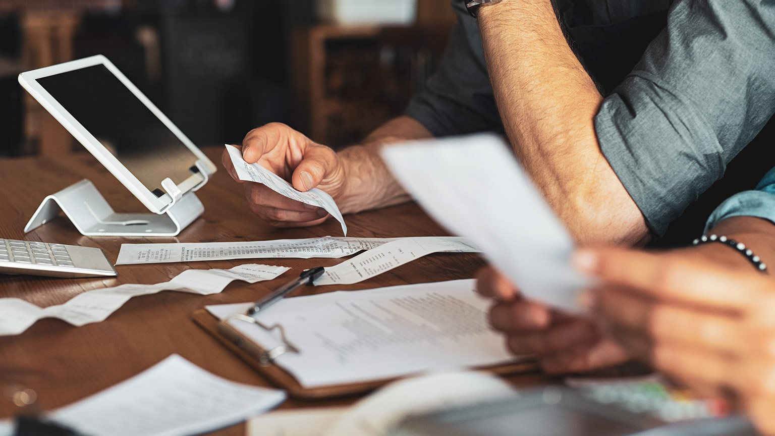 2 business owners looking over unpaid invoices