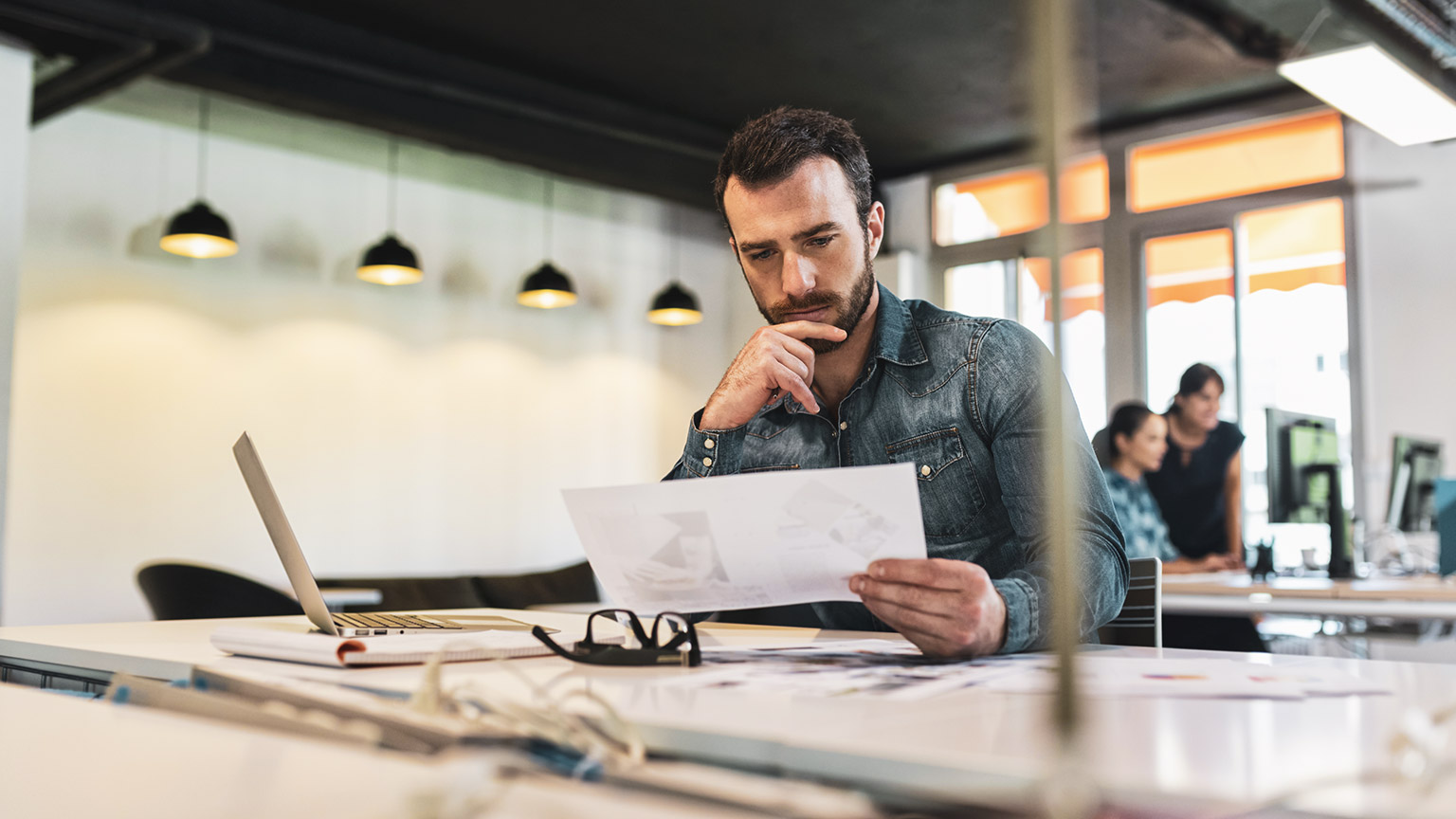 A serious startup owner looking at financial data