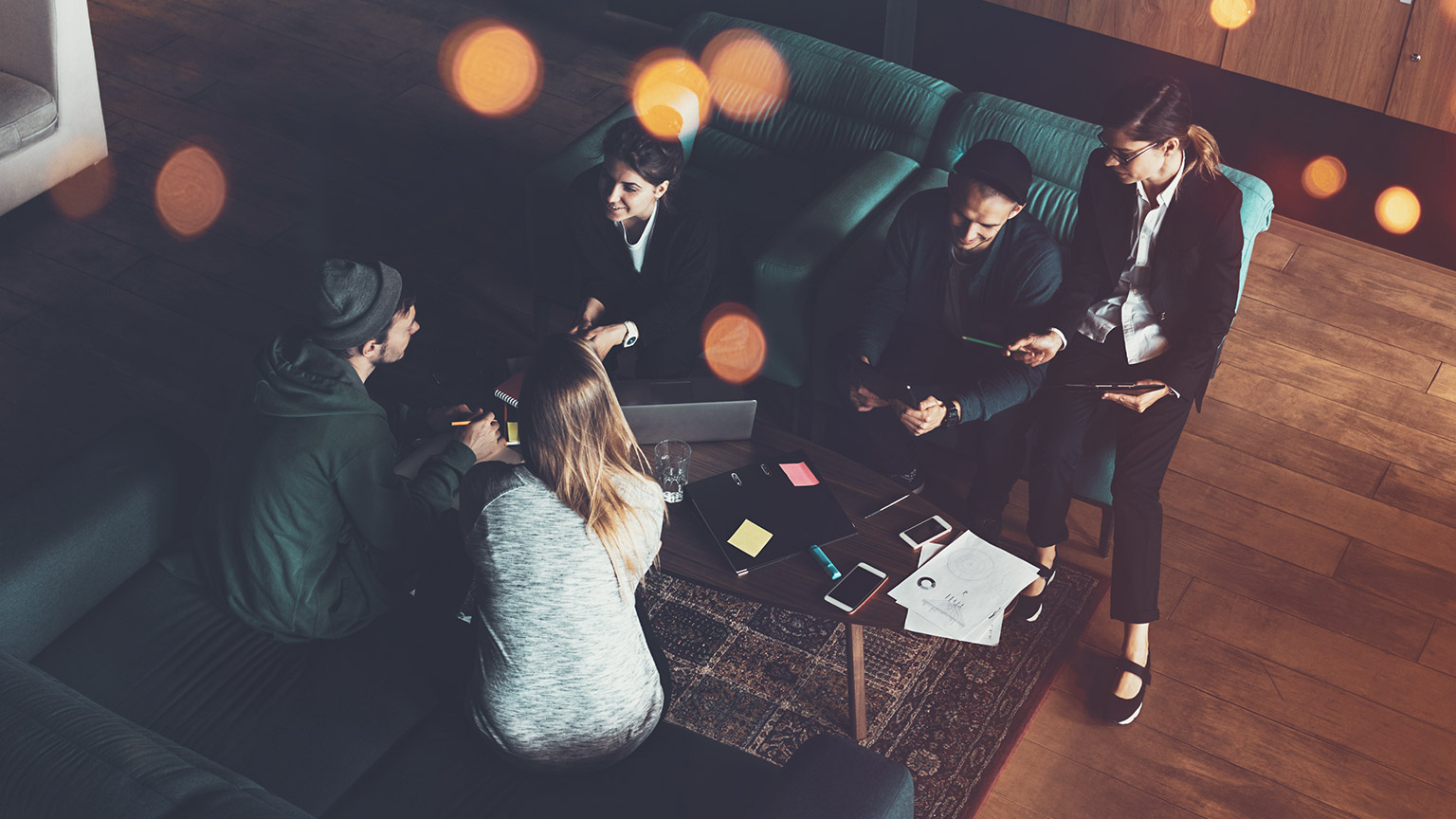 An aerial view of a group of employees sitting in a comfortable office environment