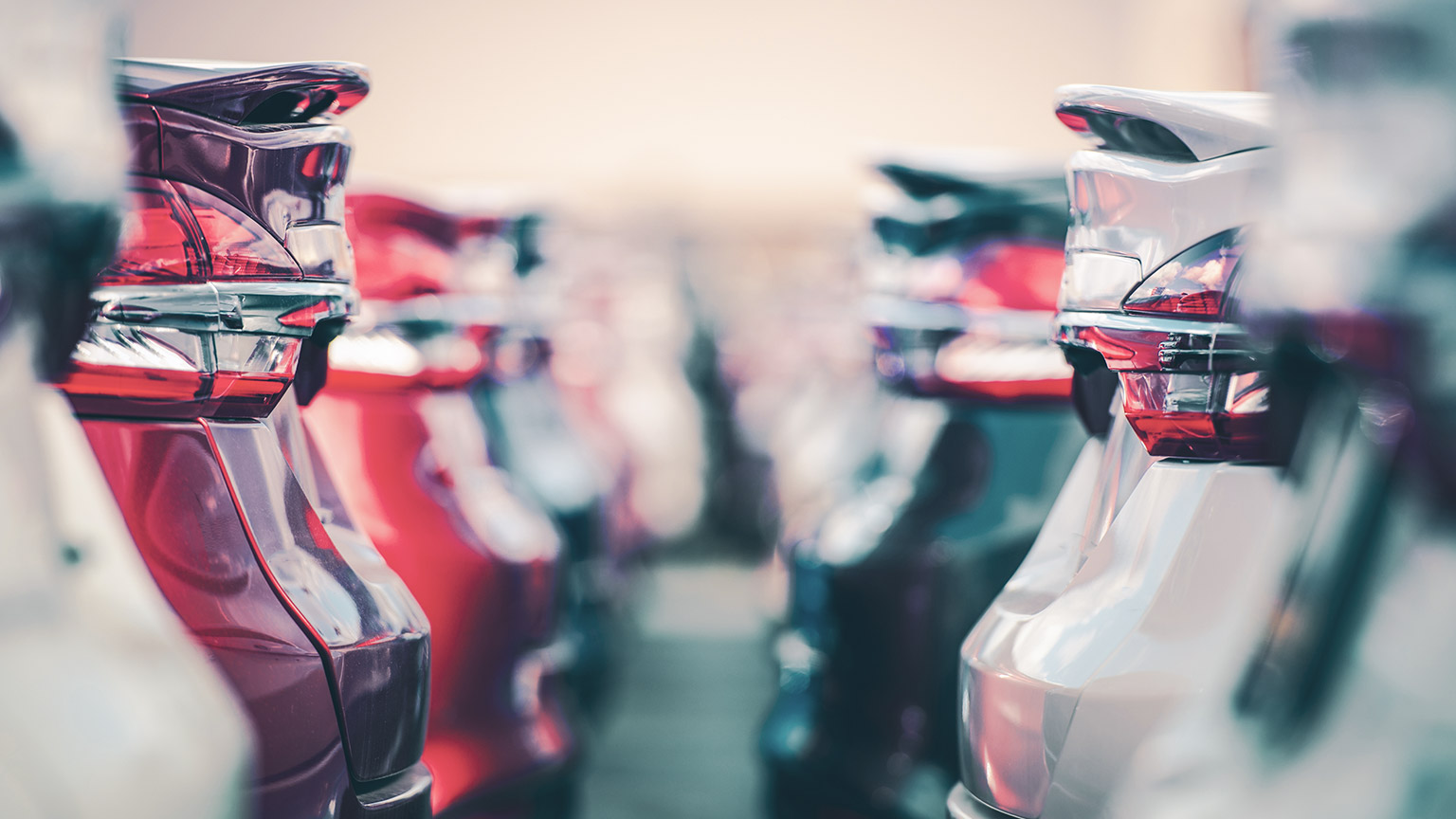 A shallow depth-of-field view between rows of vehicles