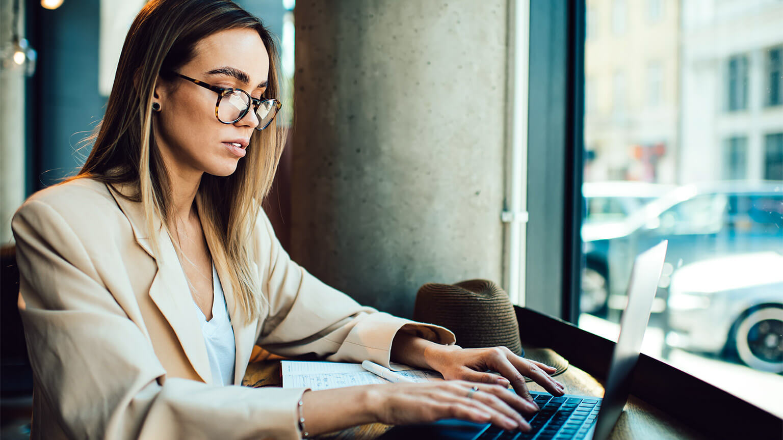 A freelancer typing up a list of resources relevant to the research they have conducted for one their clients