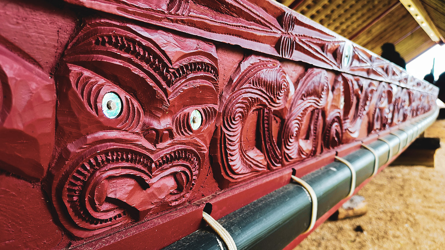 A detail shot of Maori carvings on the side of a boat