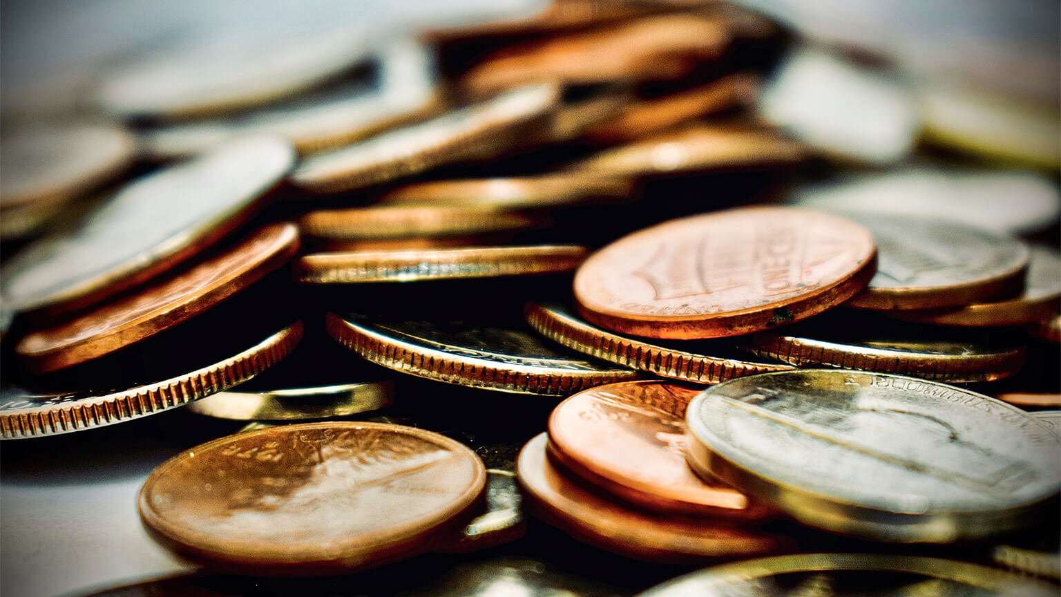 A close up of a pile of coins with different denominations