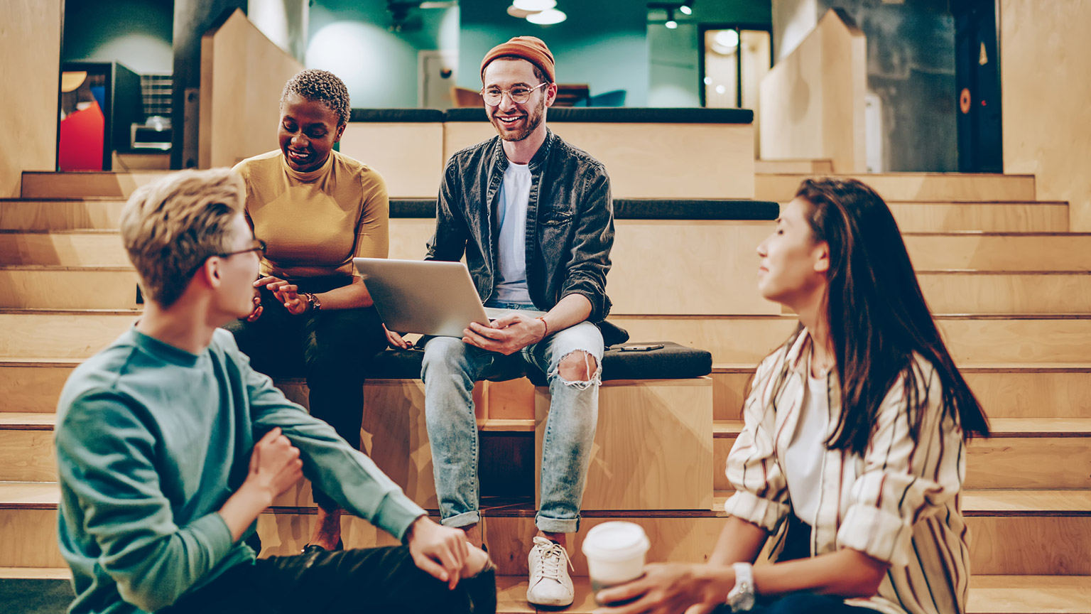 A group of designers sitting in an office collaborating on a project