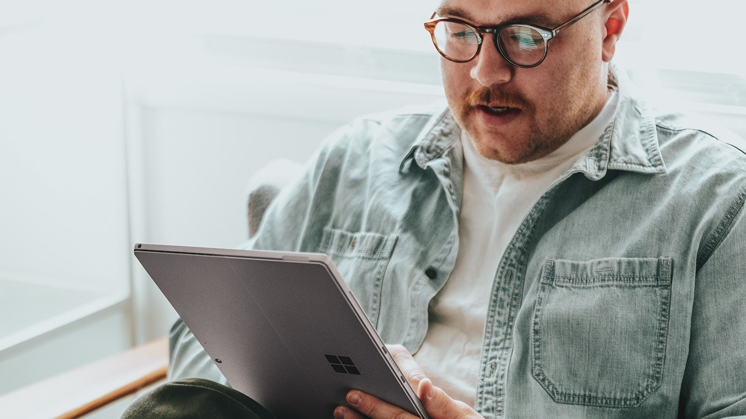 A designer absorbing reference material on their tablet device