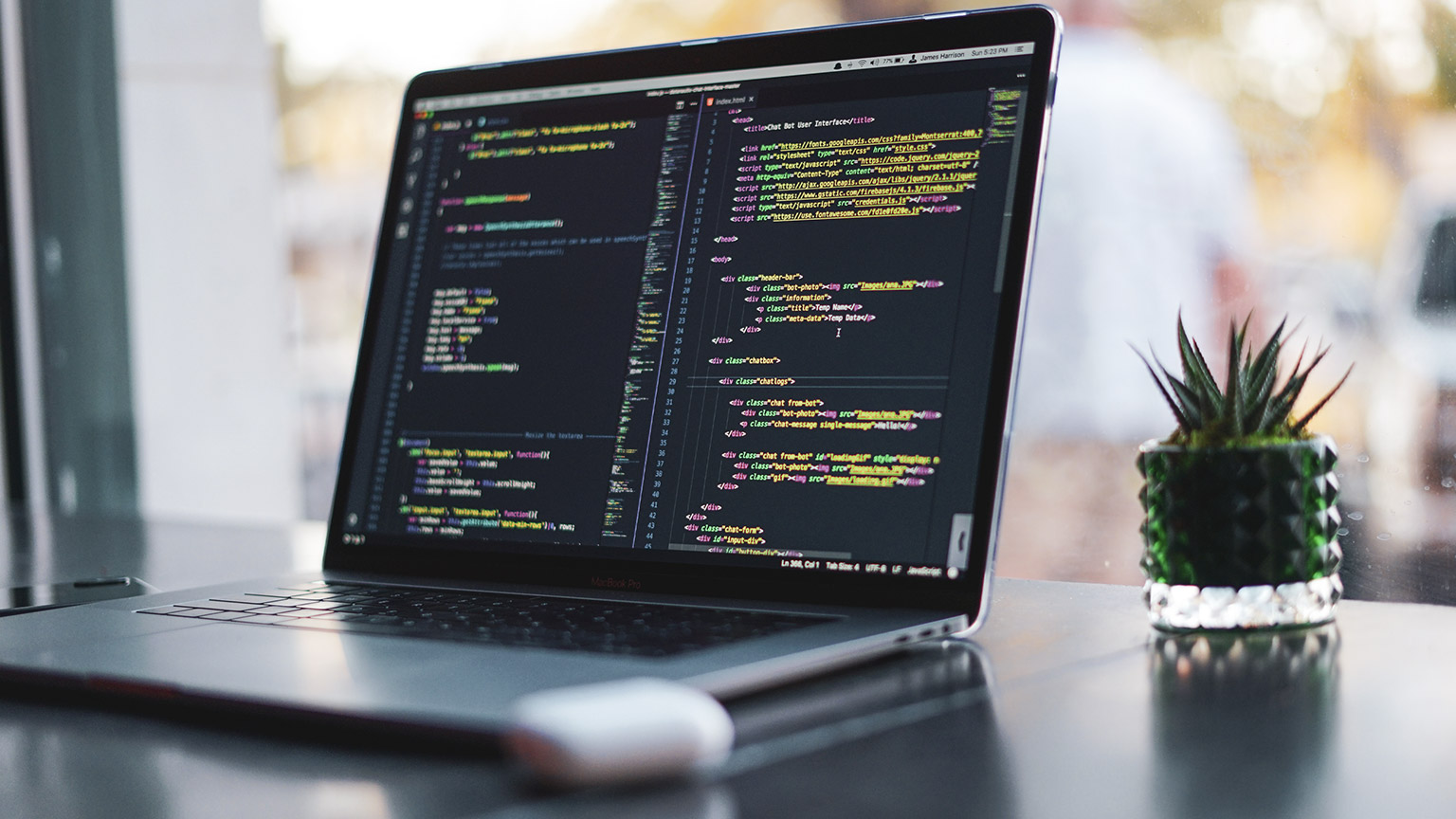 A close view of a laptop sitting on a desk with code view visible