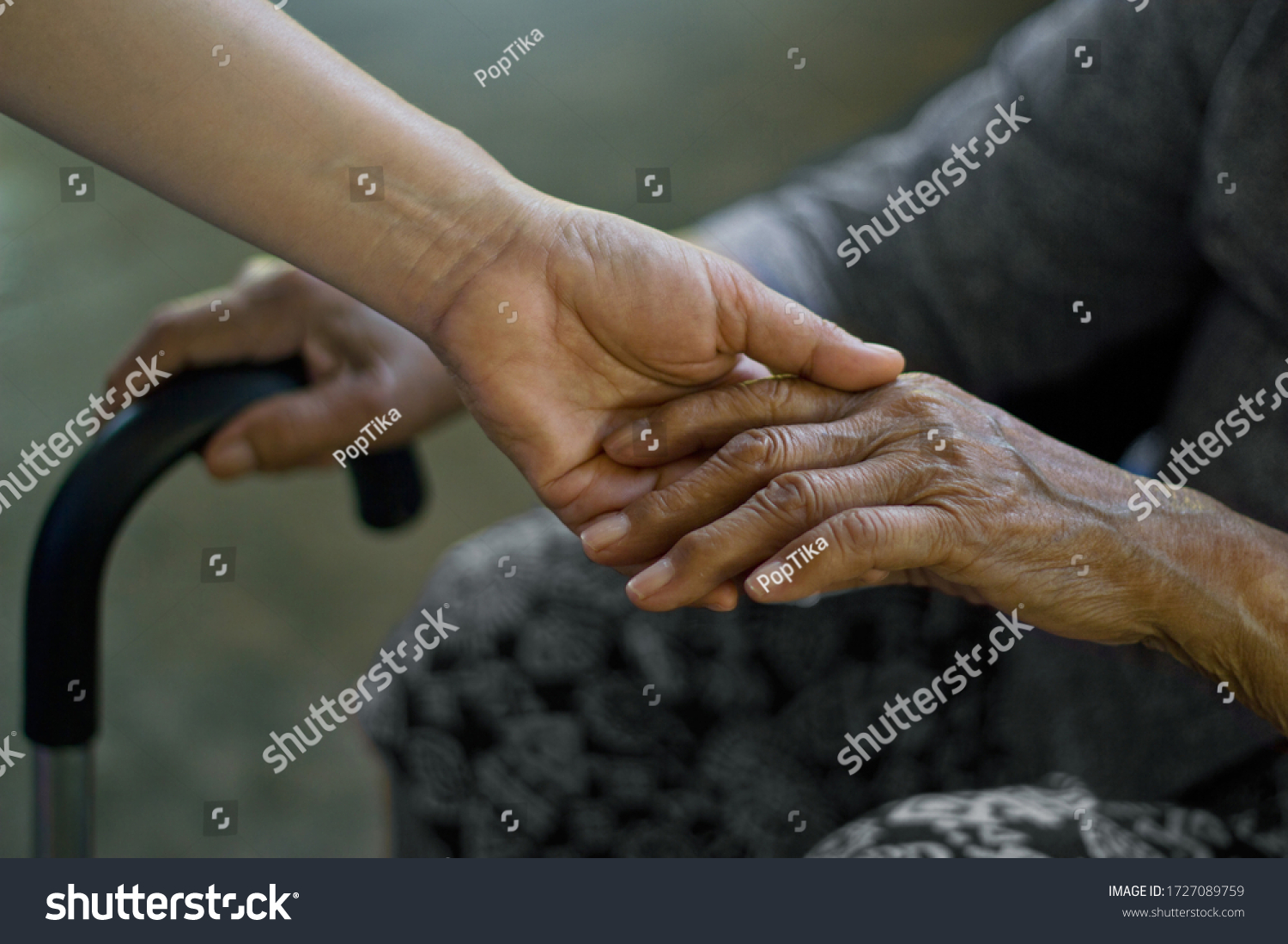 Your persons hand holding elderly persons hand