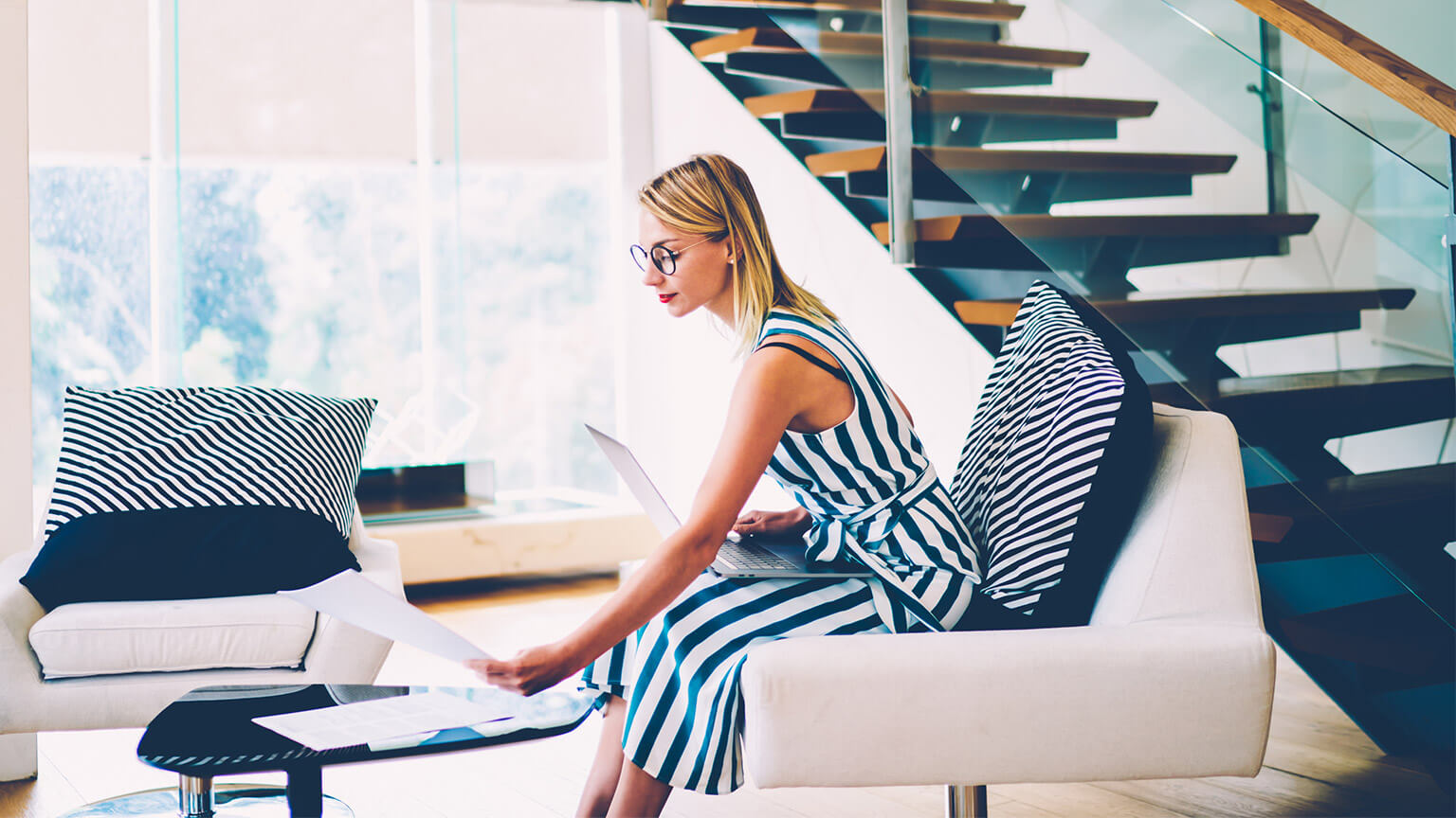 An employee working remotely, reviewing a list of their priorities, determining whether they require reordering or not