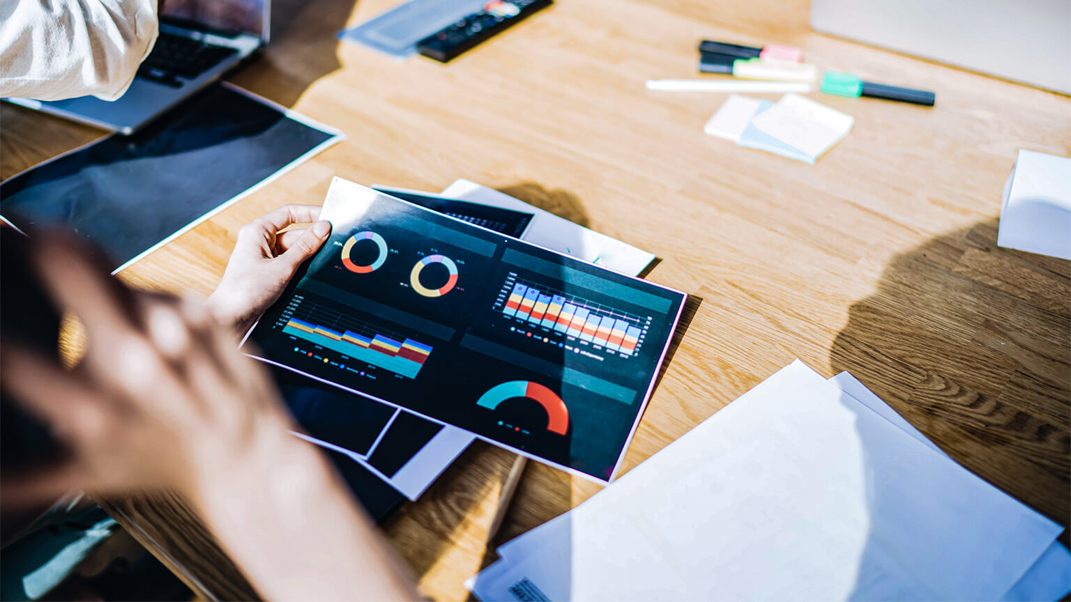 A data scientist's holding a visualisation of a large sample of data relating to their latest project