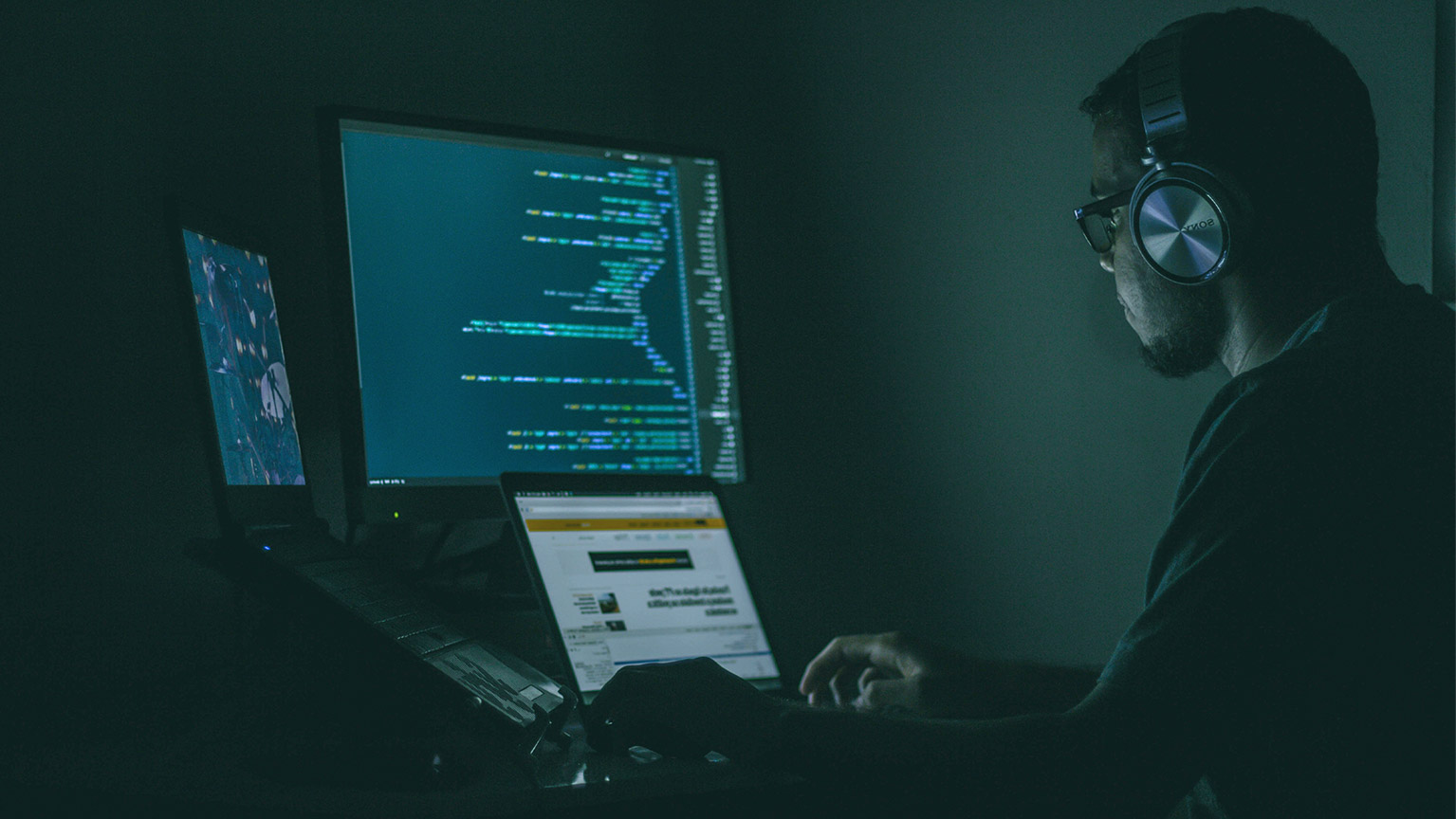 A developer working on a program in a dark room