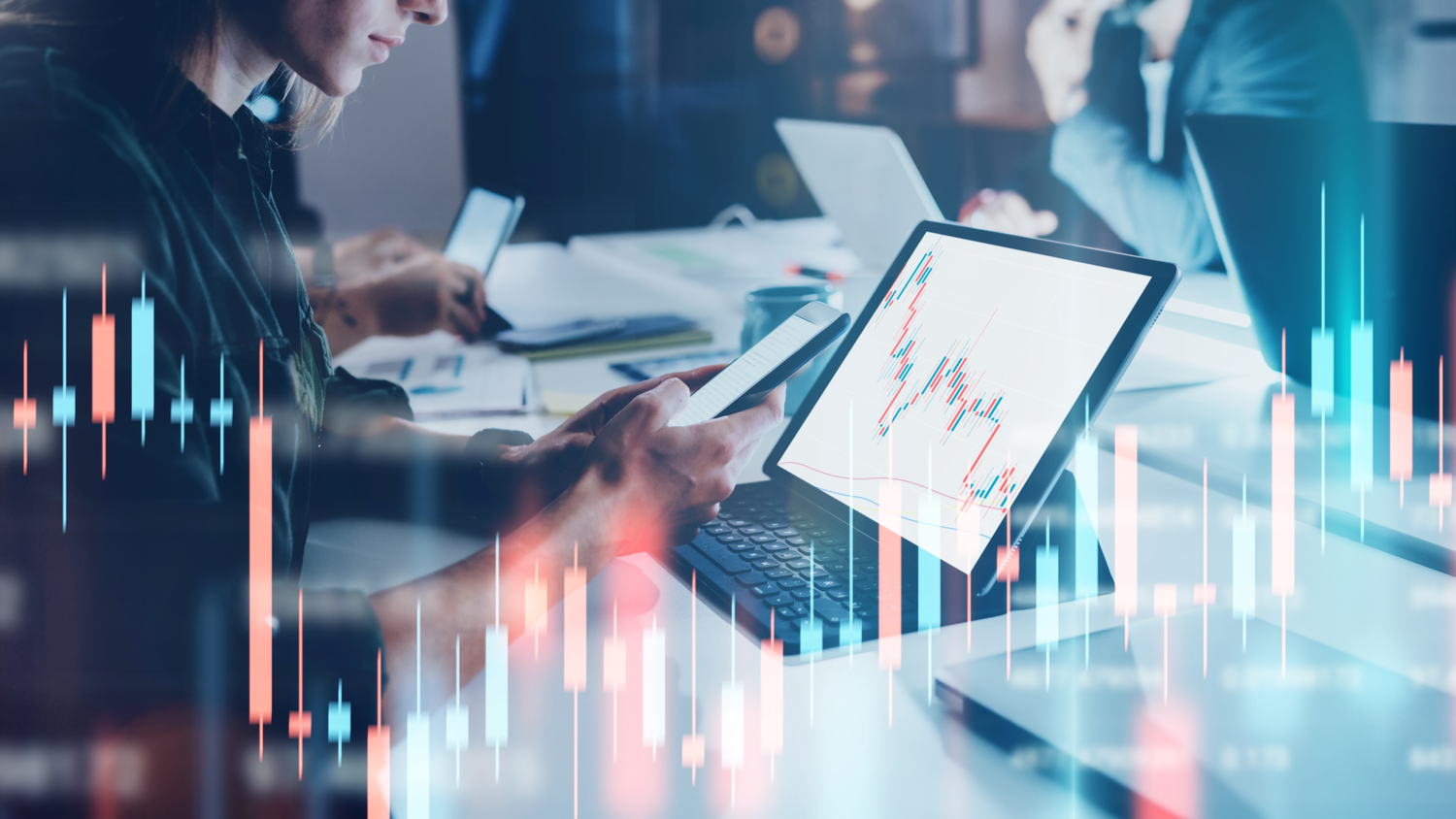 1382663132 Business woman sitting front of laptop with financial graphs on monitor