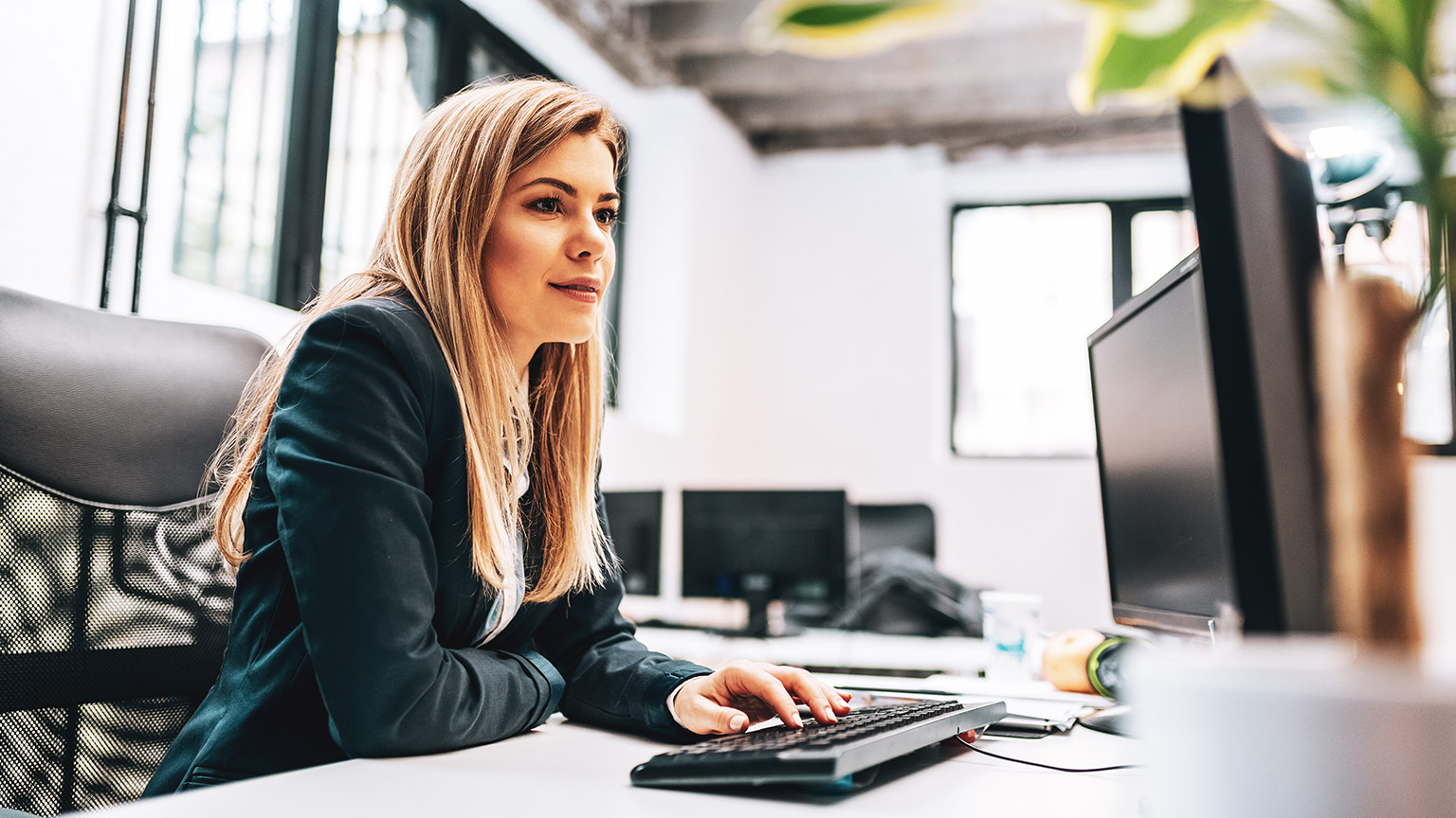 An accountant sitting at a desk working on spreadsheets