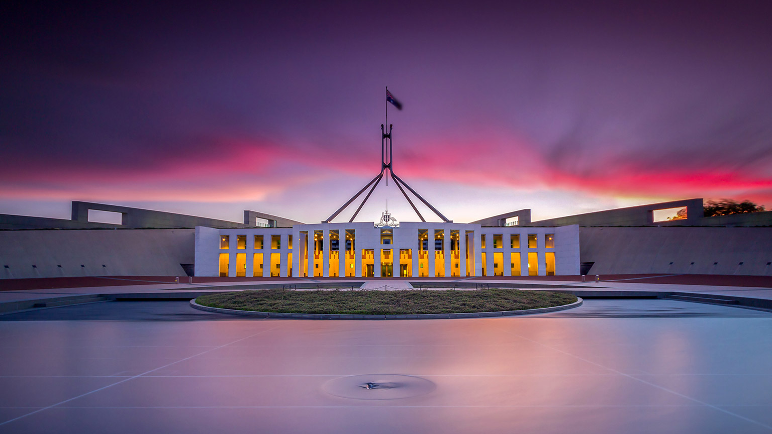 An image of Parliament House with a stunning sunset in the background