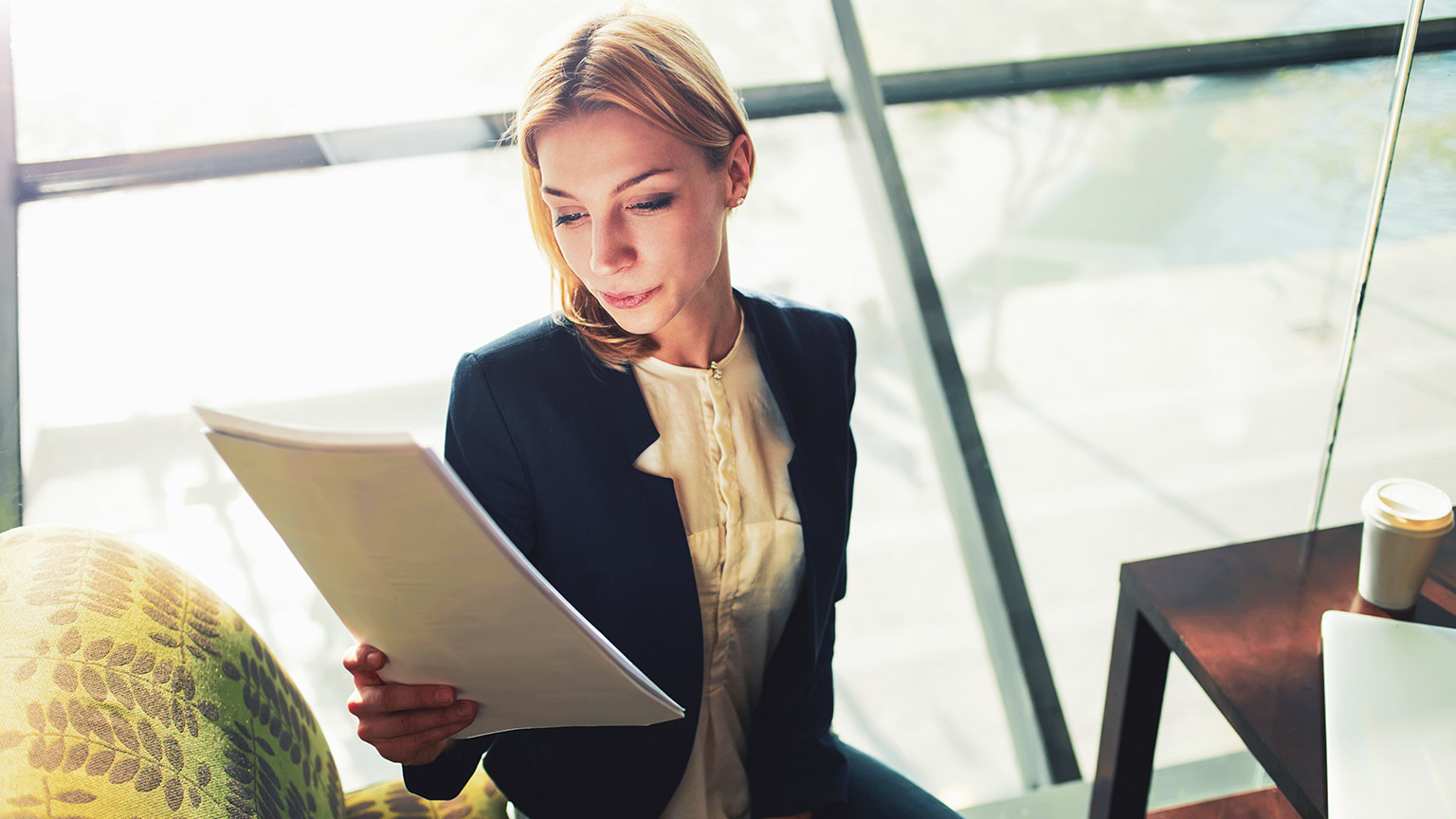 A small business owner looking over a page of legislation in an office