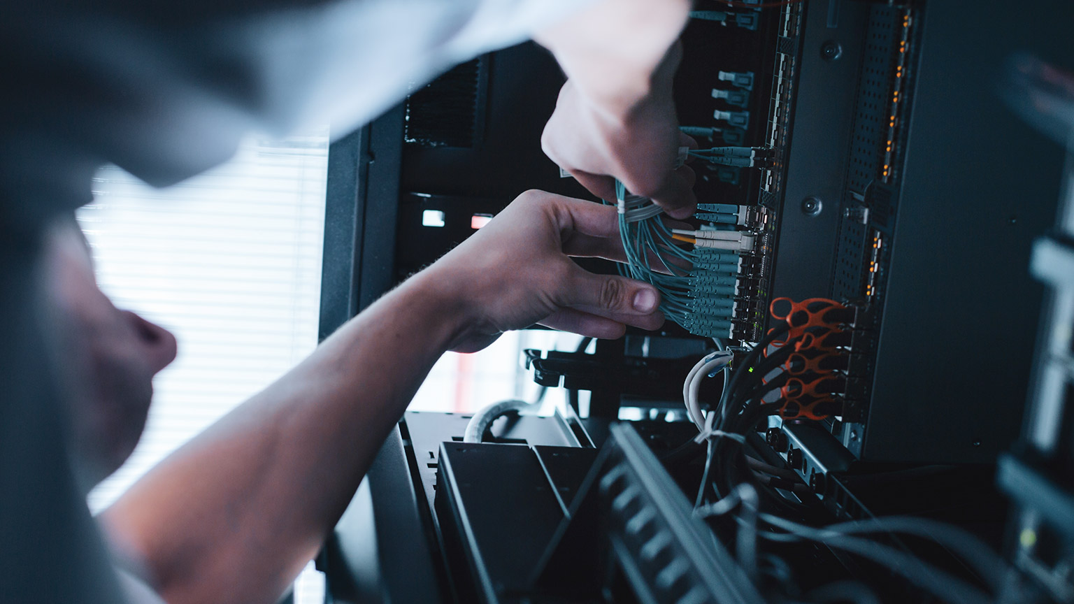 A low view of a technician installing network hardware