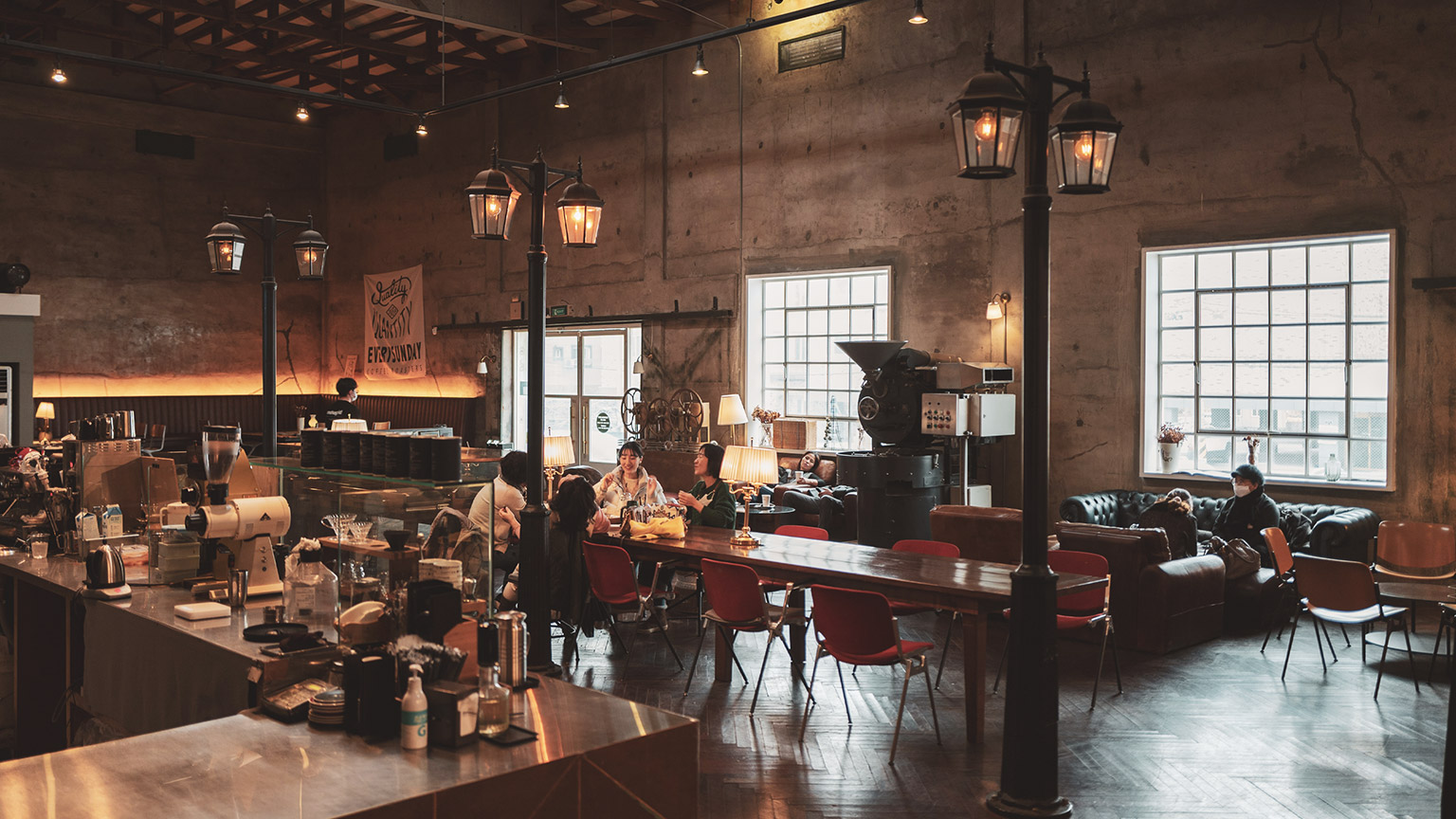 A wide interior view of a trendy cafe