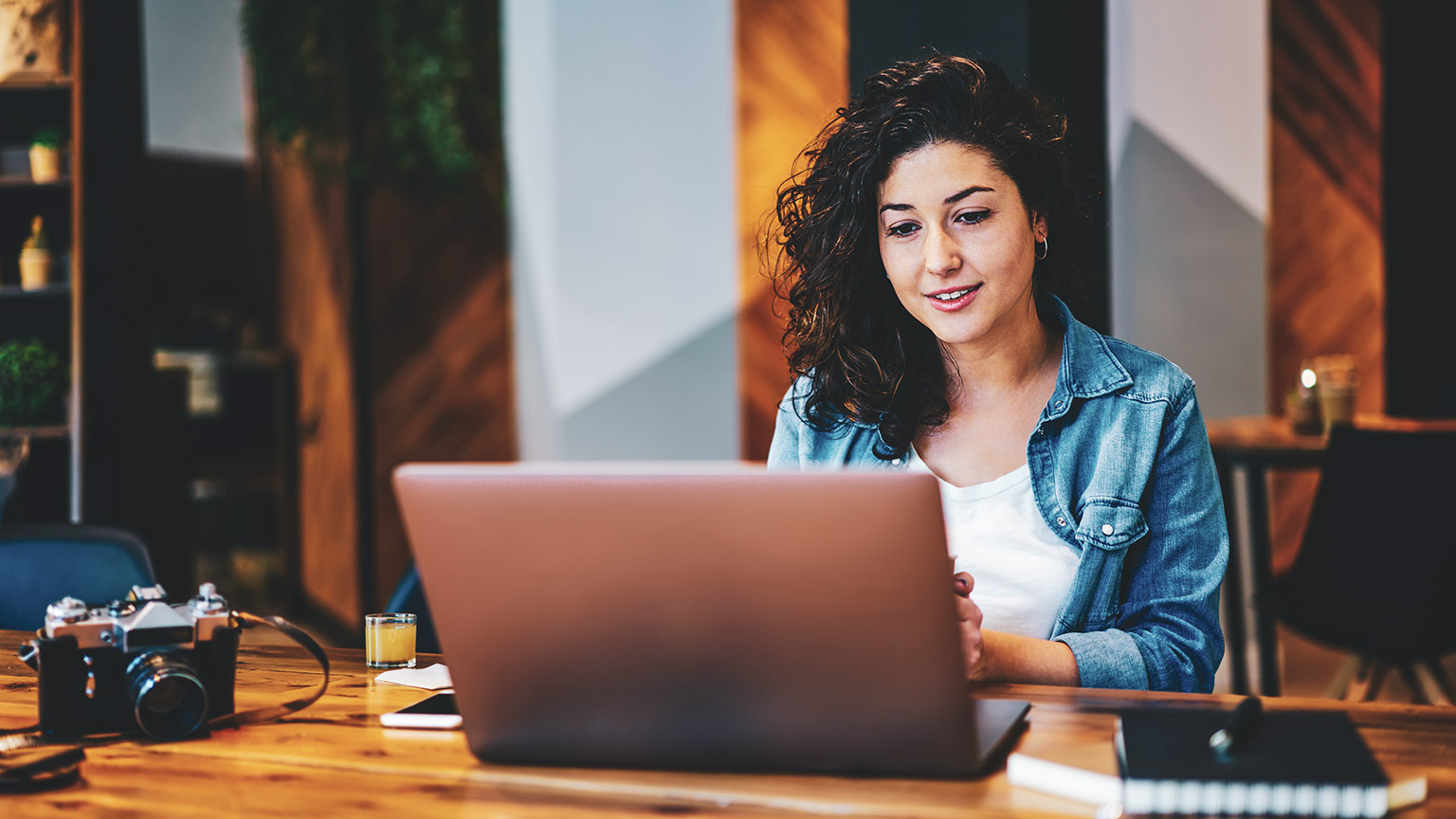 A copywriter working away on a laptop