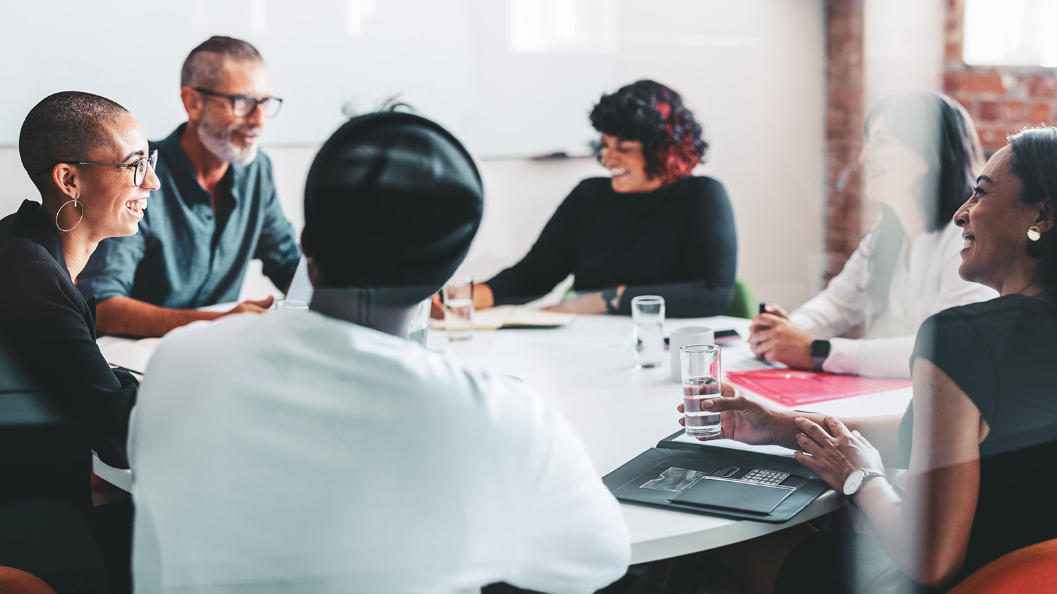 A group of business employees sitting around a boardroom table