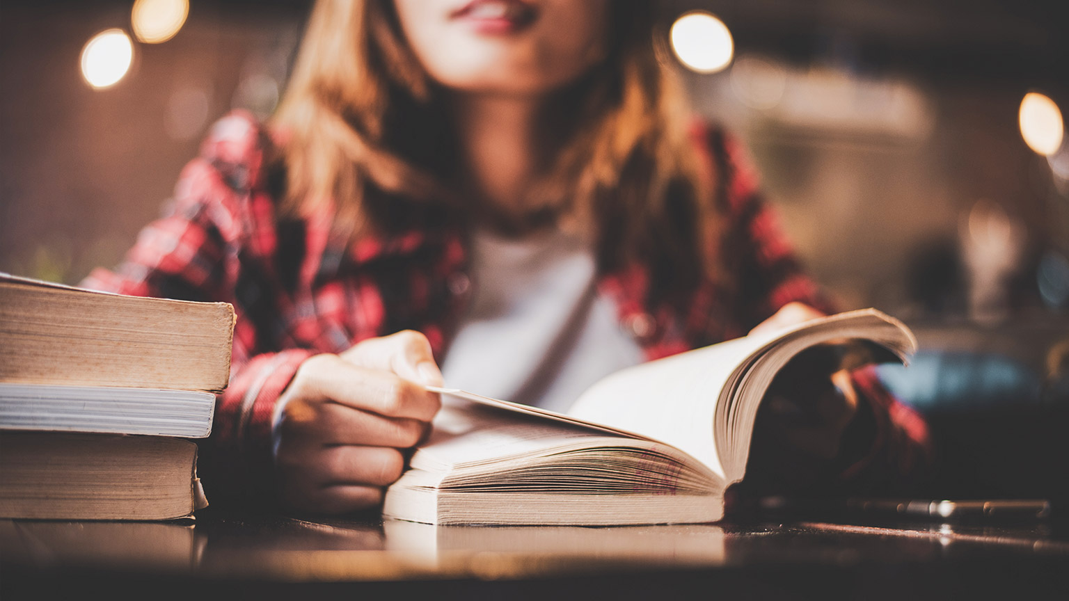 Close view of a student accessing reference materials in a library