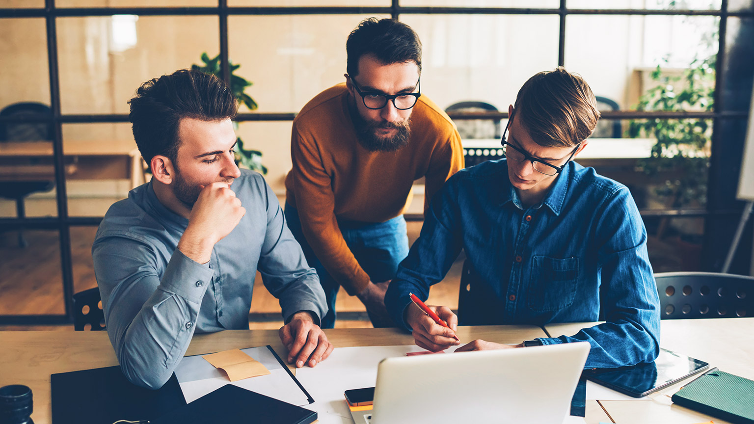 A group of marketers discussing the financials of their next campaign