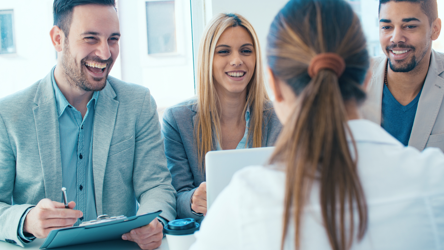 Job applicant having an interview.Group of business people having job interview with young woman.