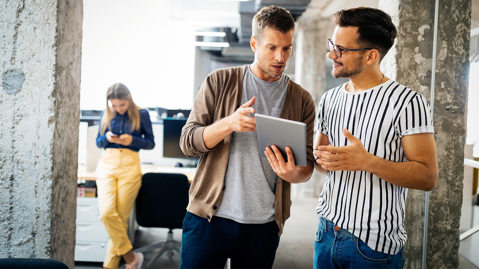 Employees discussing and developing a business plan on a tablet