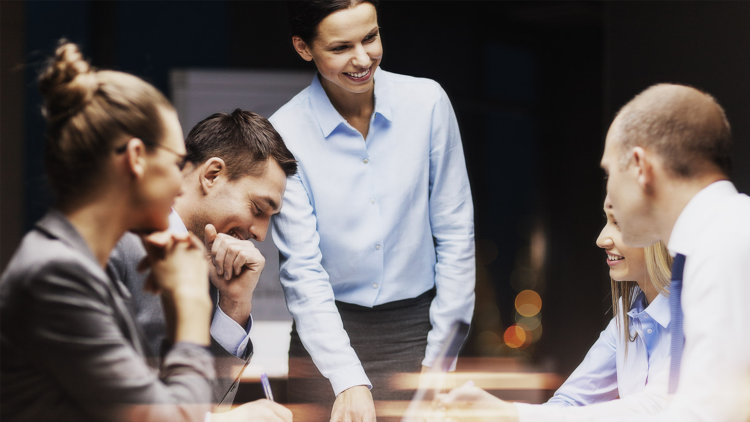 A group of employees happily working and interacting together