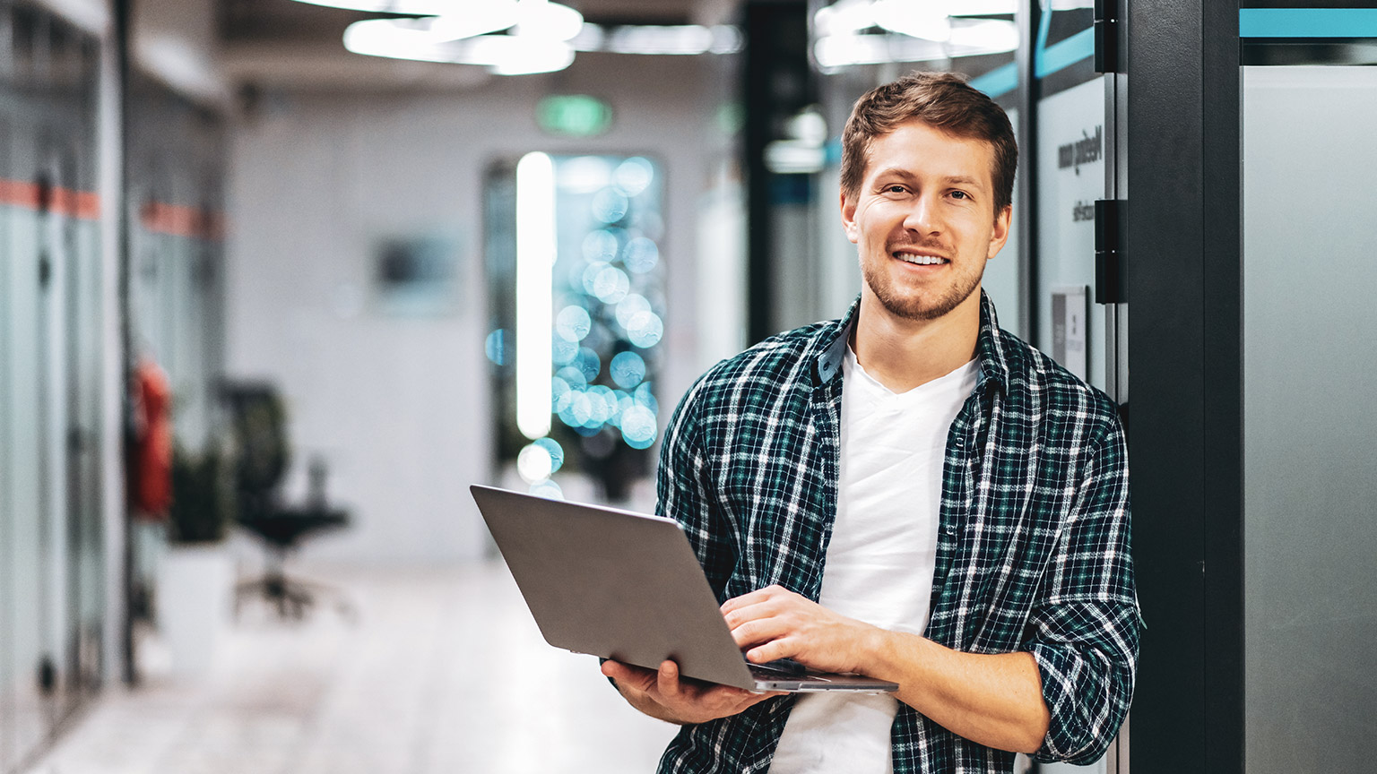 A young entrepreneur standing in a modern office space