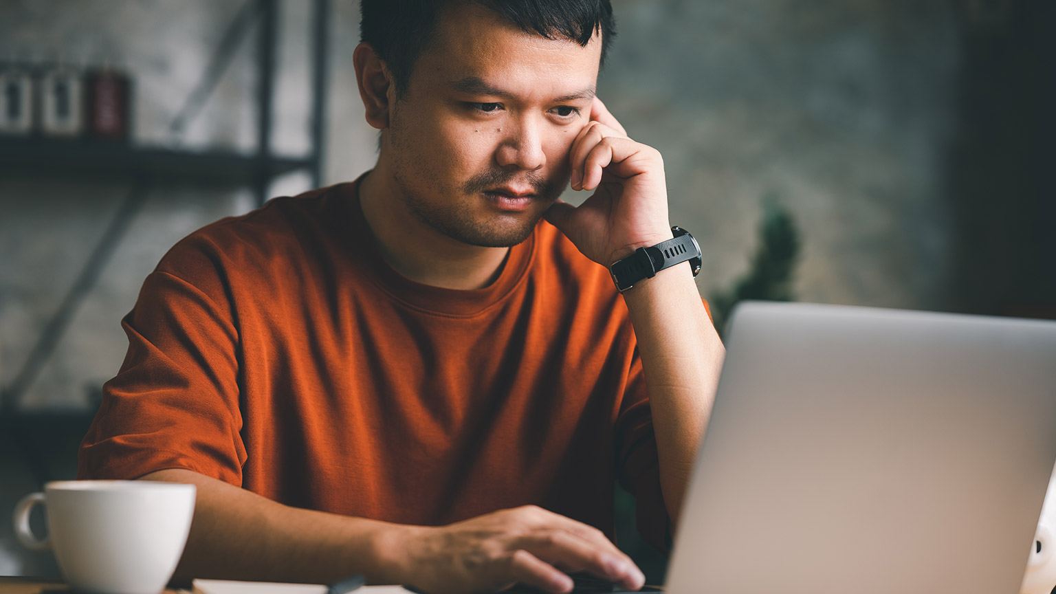 A young entrepreneur working on a project on a laptop