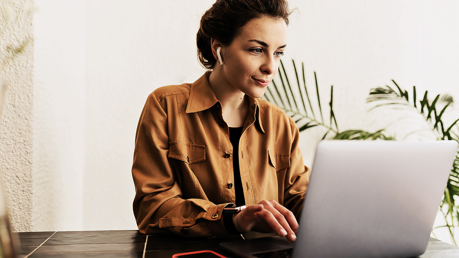 A programmer seated at their desk, casually working on their organisation's codebase.